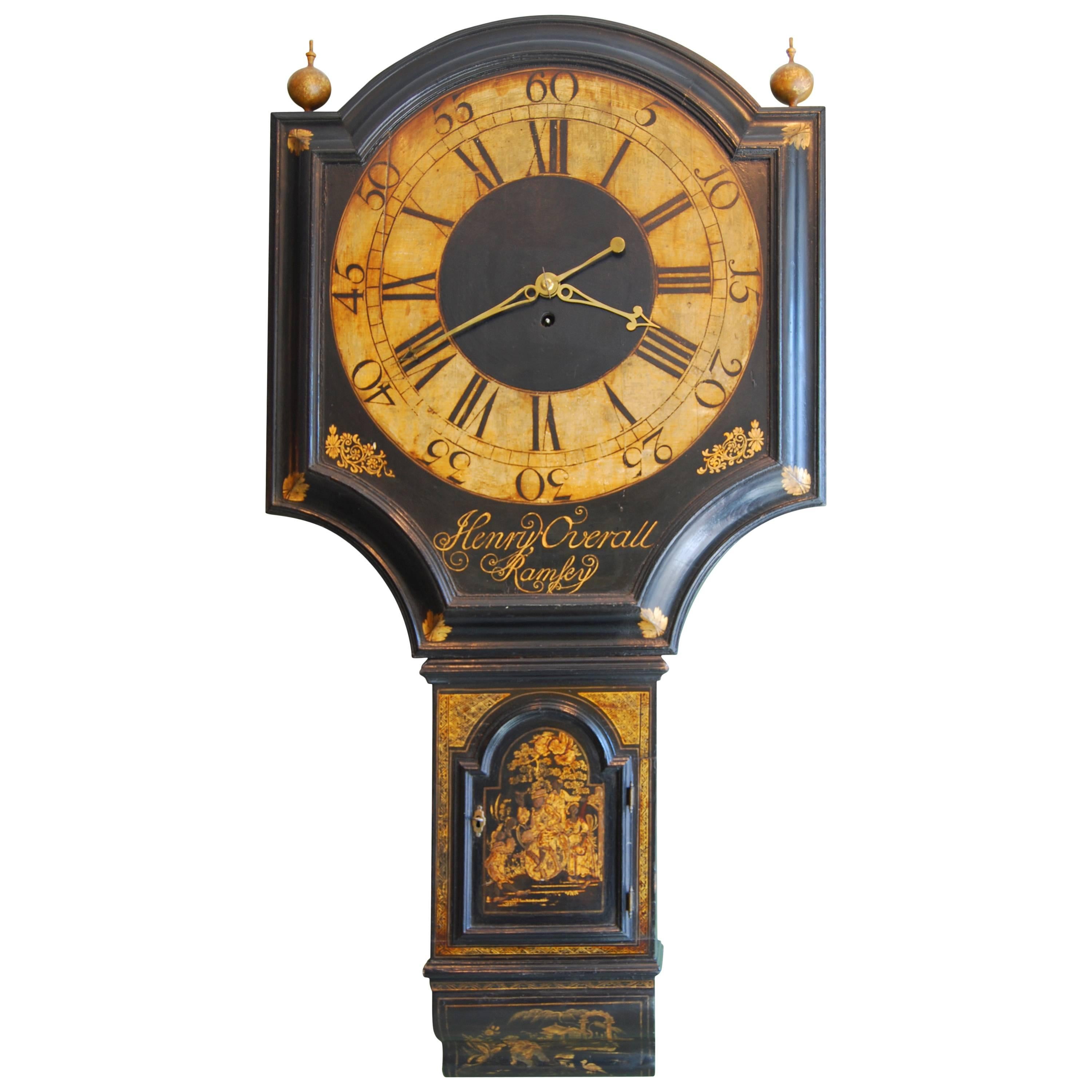 A truly rare and exceptional George III period black lacquer Tavern Clock by Henry Overall, Ramsey.

This has an access door to the right side and a shallow concave moulded foot. The shield dial is well proportioned and the broad moulded surround