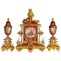 Ormolu-Mounted Sevres Style Ruby Ground, Jeweled Three-Piece Clock Garniture