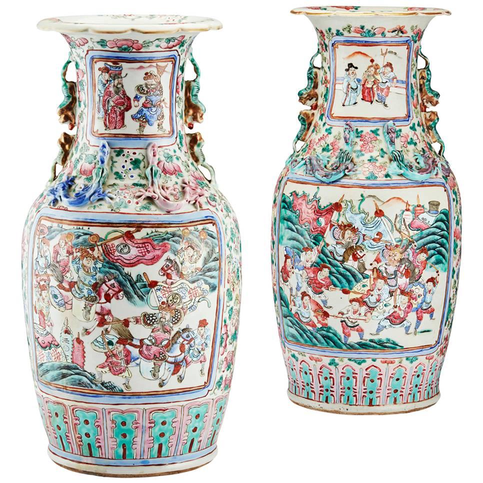 A fine large close pair of late 19th century famille rose porcelain vases.
Canton, China, Qing dynasty, Guangxu period (1875-1908).

Each vase is shaped in baluster form with flared scalloped rim, having moulded Chilong dragons applied to the