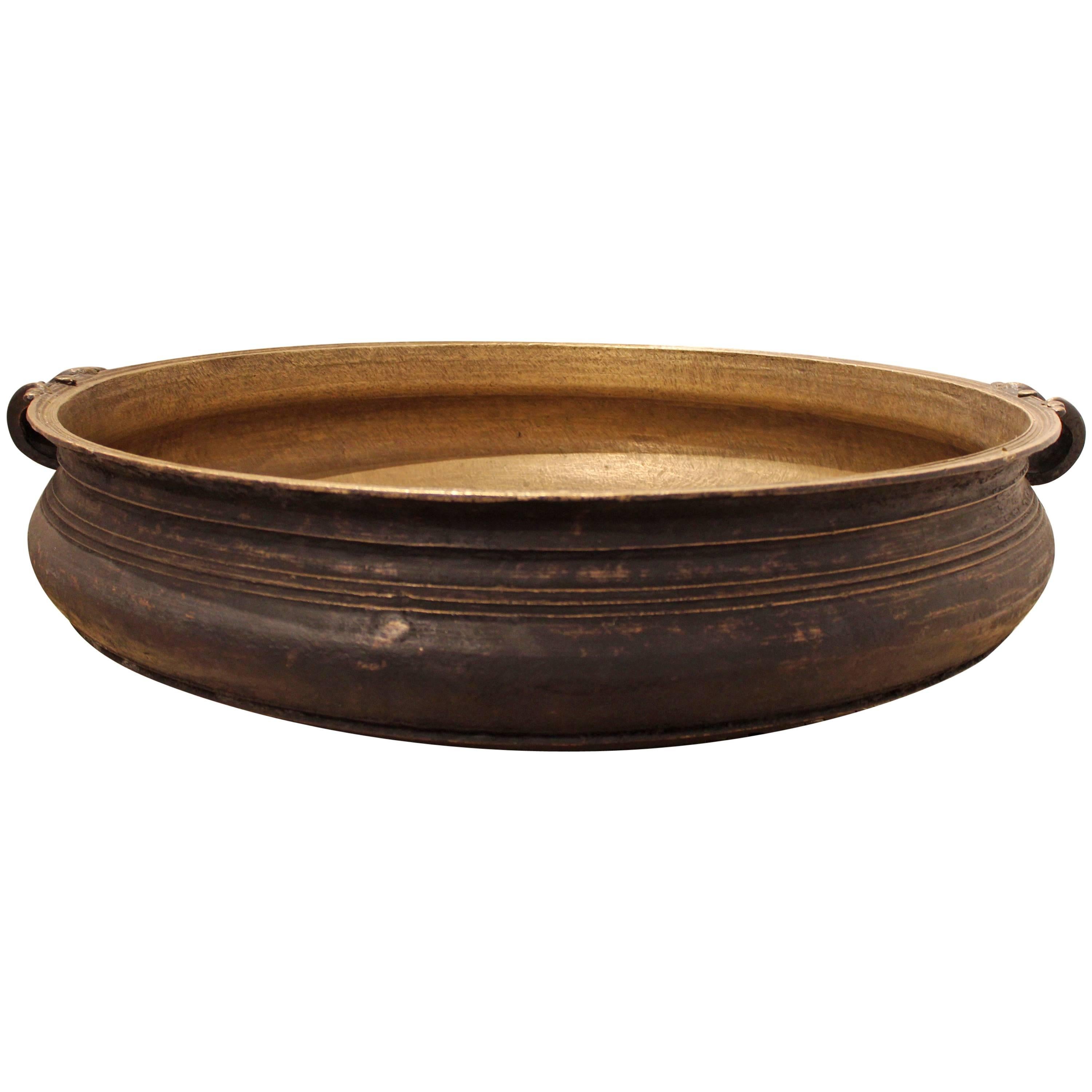 Antique cast bronze urli bowl, Southern India
 Cast bronze pot is from Southern India. Pots were placed directly on a fire and large meals were prepared for special events, weddings, and religious holidays. Made from a lost wax process done in the