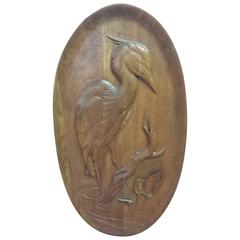 A Finely Carved "Blue Heron" on a Butternut Wood Oval Panel Wall Hanging