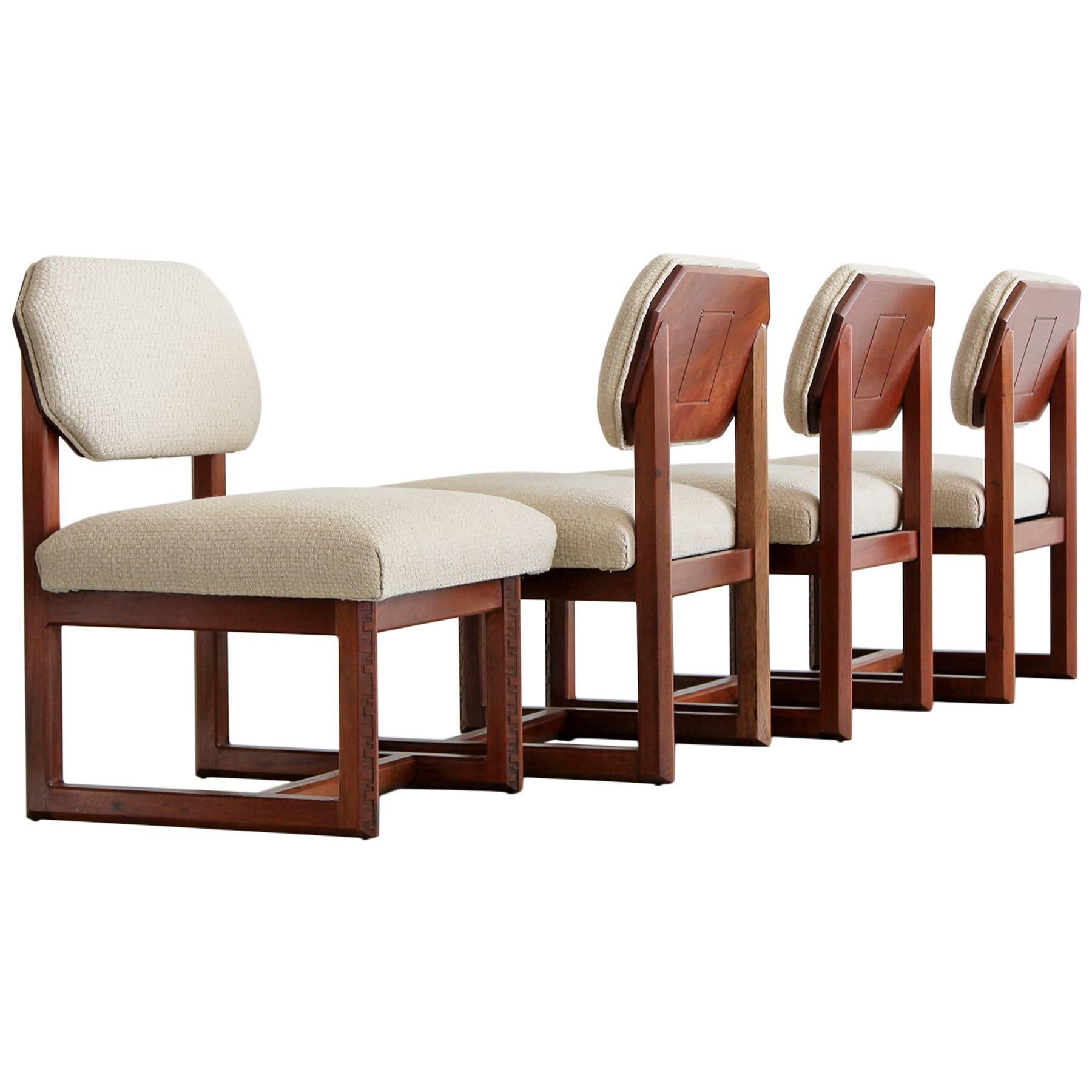 Low profile game table set with 4 matching chairs by Frank Lloyd Wright for Heritage Henredon. Signature carved Taliesin frames with floating octagon shaped back each with carved wood. Wonderful grain to wood and incredible craftsmanship.  Newly