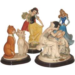 Collection de quatre figurines de personnages de Giuseppe Armani Disney