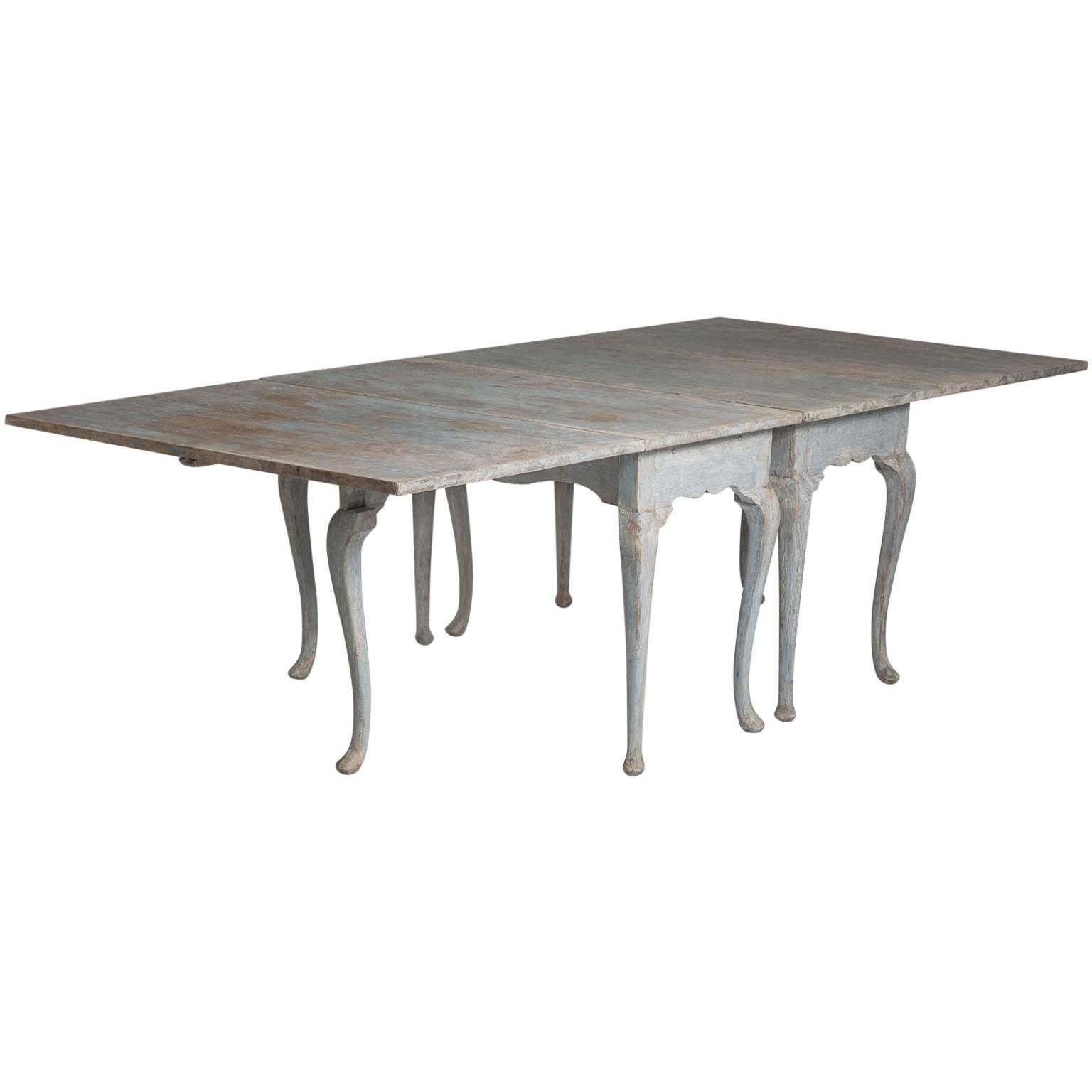 These versatile tables can be used as consoles standing against a wall or as single dining tables seating six. They truly shine as one long dining table those measures 98” long by 47” wide, seating 10-12 comfortably. The grey paint is