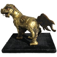 Ravissant lion bouddhiste tibétain en bronze doré
