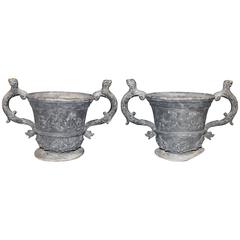 Pair of Lead Urns with Figural Handles and Cherub Decoration