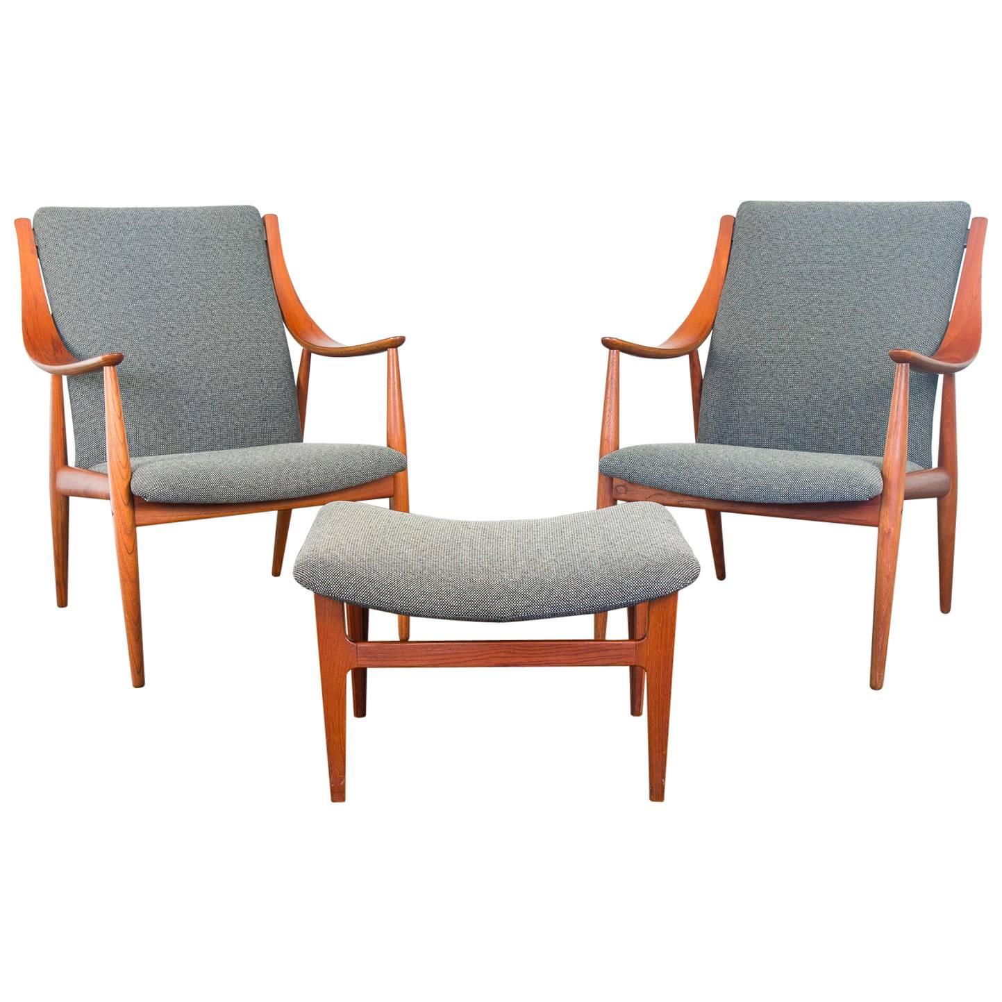 Peter Hvidt FD148 Easy Chairs and Ottoman set for France & Son distributed by Jon Stuart Inc. A brilliant pair of lounge chairs with curvilinear arms accompanied by an ottoman foot rest. The chairs and fixed cushion are faithfully upholstered with a