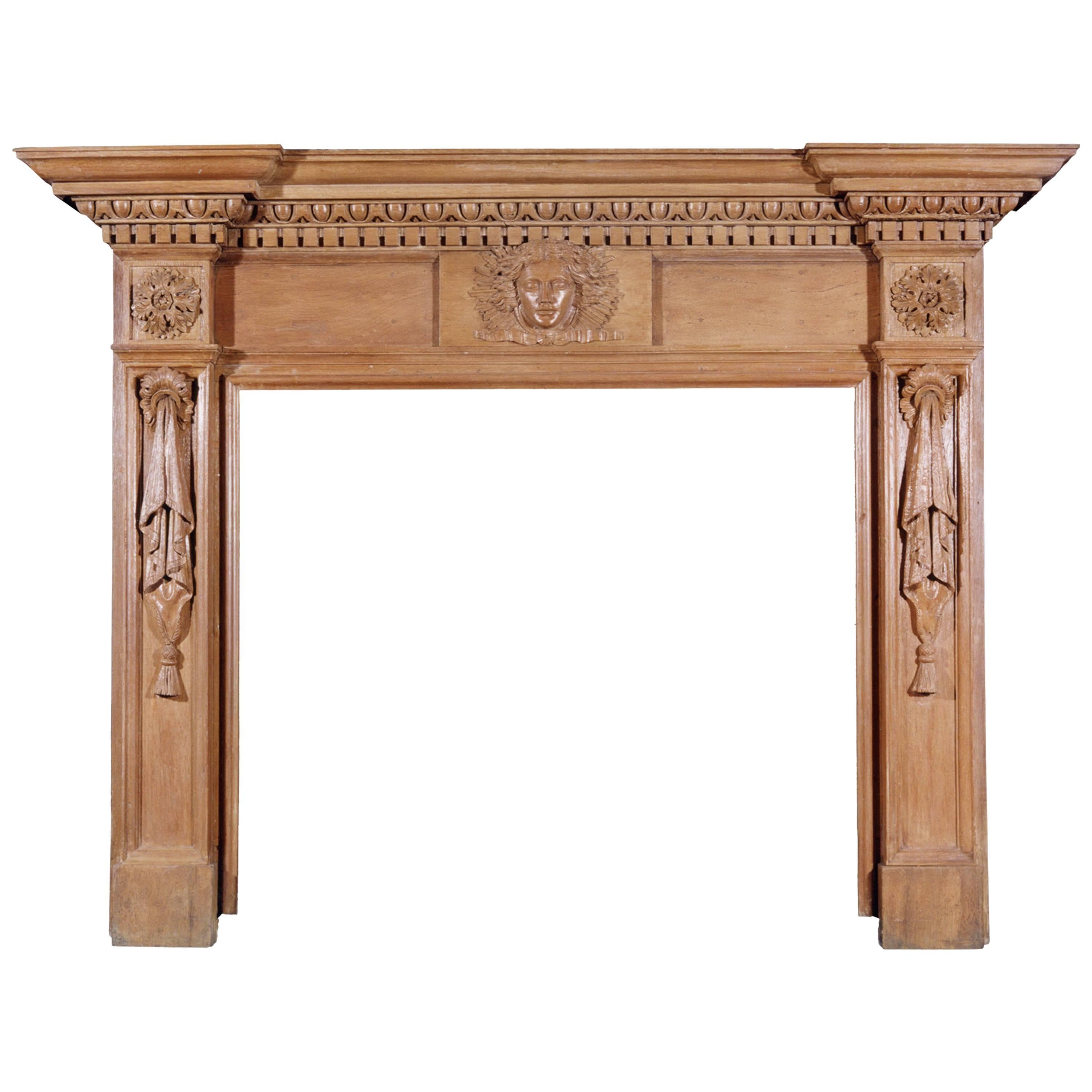 A 19th Century English Oak Fireplace with Carved Mask to Centre For Sale