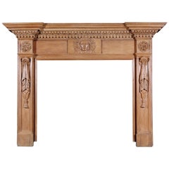A 19th Century English Oak Fireplace with Carved Mask to Centre