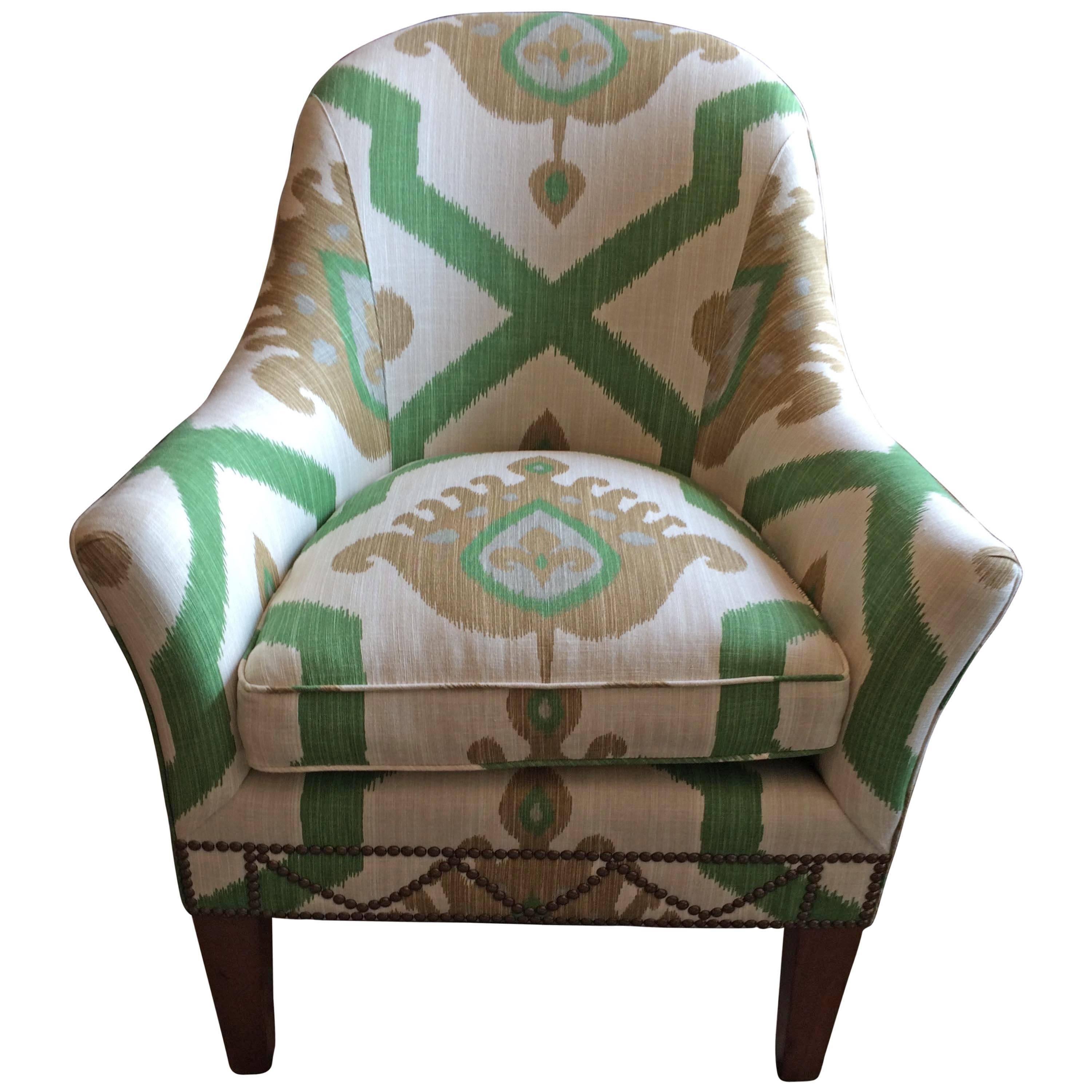 Comfy vintage club chair newly updated in Thibaut Ikat fabric and schnazzy brass nailheads around the bottom. Mahogany legs.
A darling crescent shaped ottoman is also included.

KJ