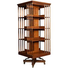 Large Edwardian walnut and ash four-tier revolving bookcase