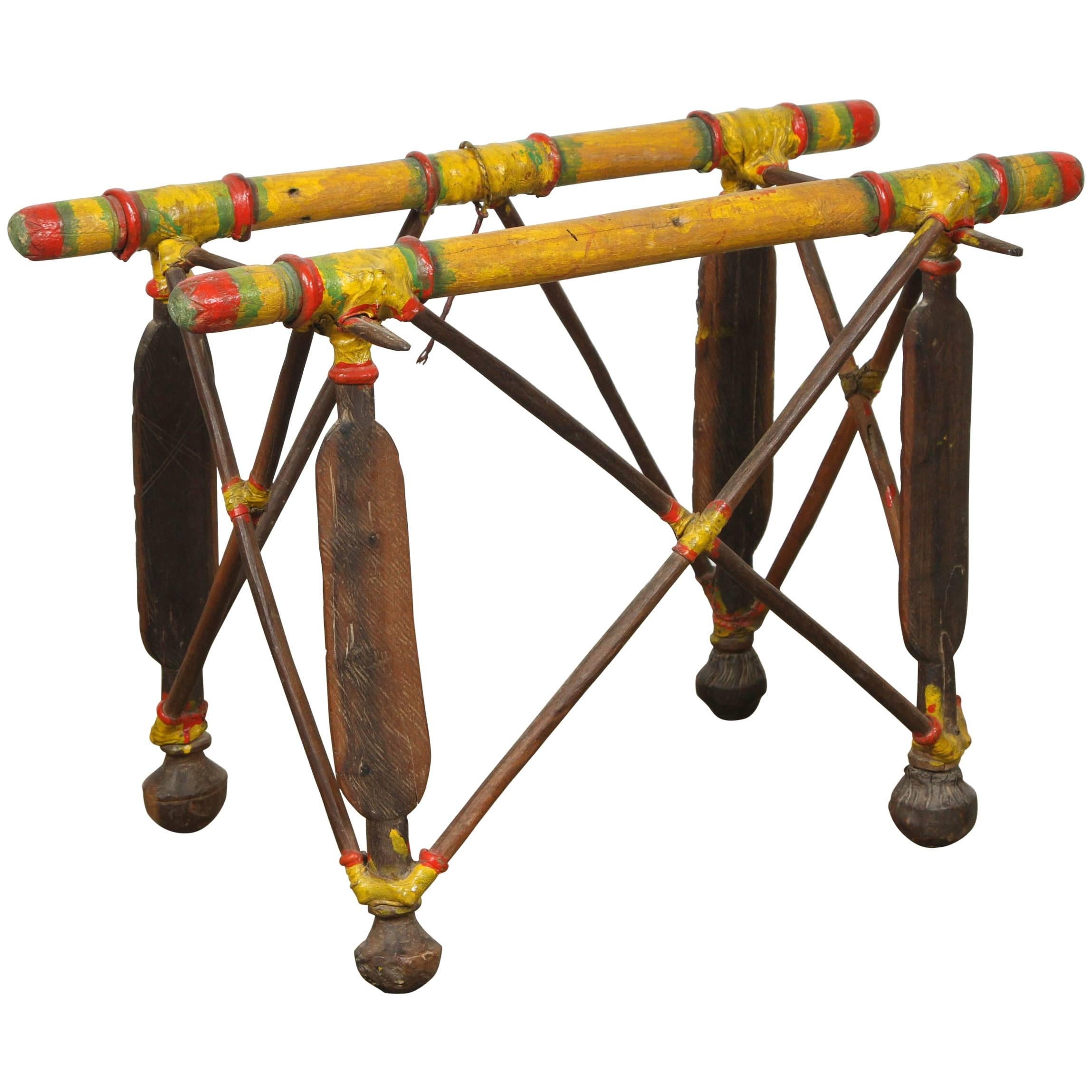 African tribal Tuareg Camel saddle stand table.
Made of wood hand-carved with Tribal designs and leather hand-painted in yellow, green and red.
Nice sculpture Artifact from the Nomadic people of the African Sahara Desert. 
This is a smaller version