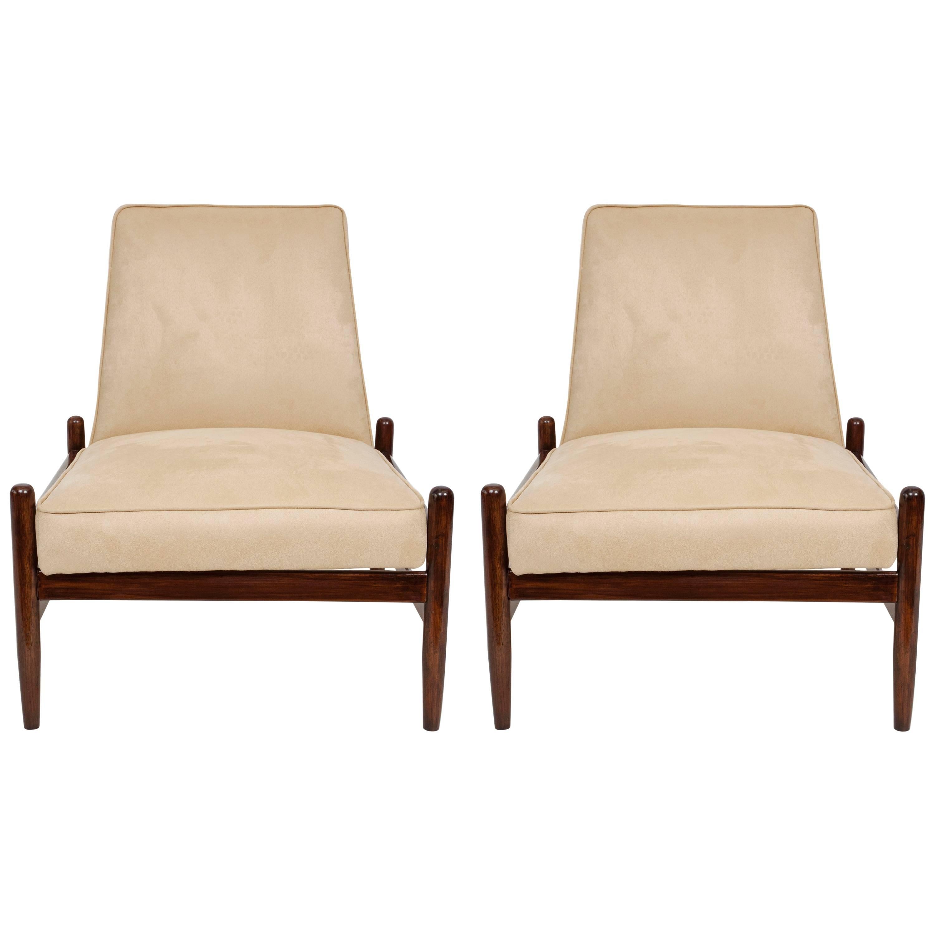 A pair of Brazilian modern lounge chairs, produced circa 1960s by Liceu de Artes & Oficios, back and seat upholstered in light beige faux suede, on jacaranda wood frames. Very good vintage condition, recently reupholstered.

10834
