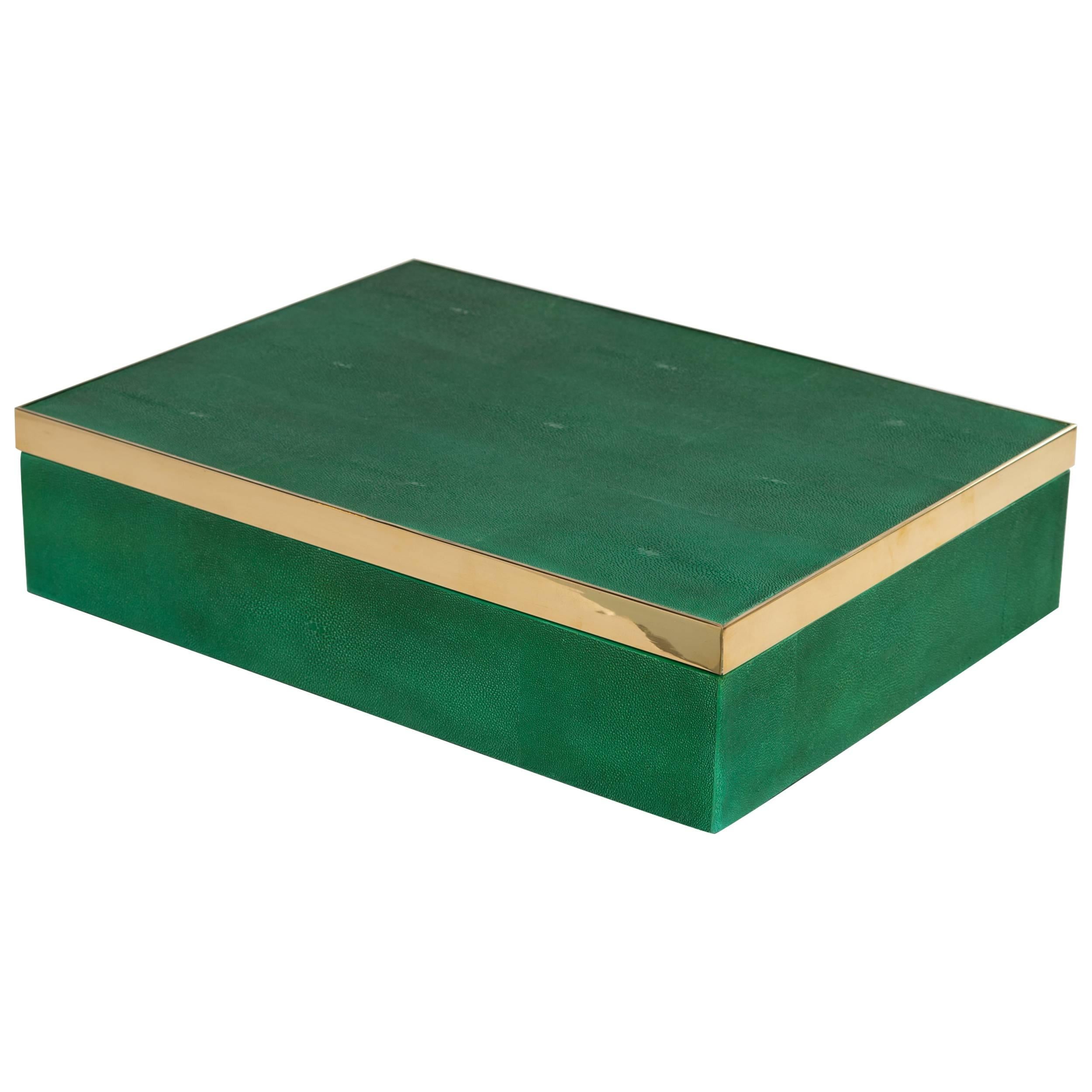 Exquisite hand-crafted luxury box in hand dyed emerald green stingray. The box has an extra large rectangular form with brass banded accent along the lid. Lined with black velvet felt interior.