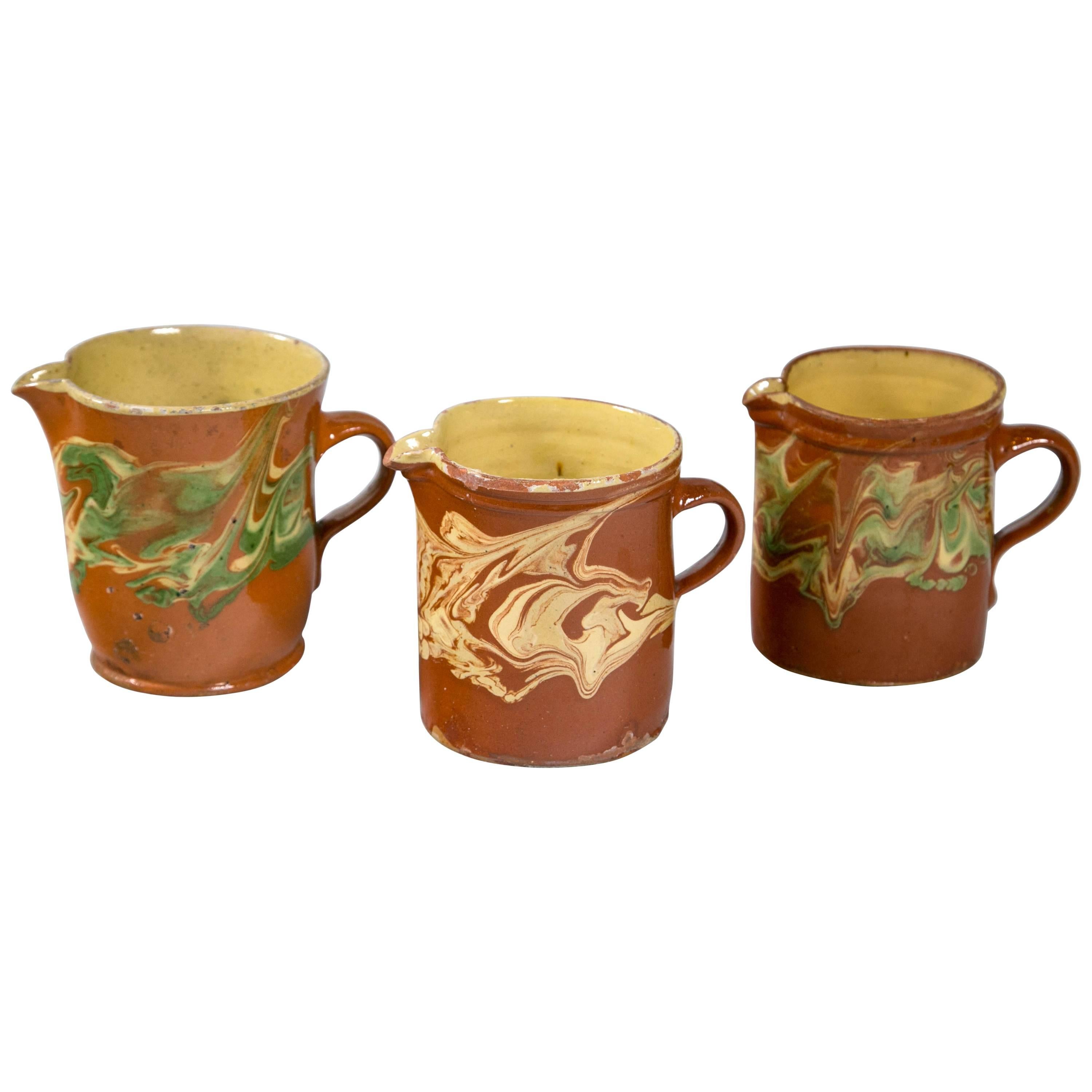 Collection of Three 'Jaspe' Pottery Pitchers, France, Late 19th Century