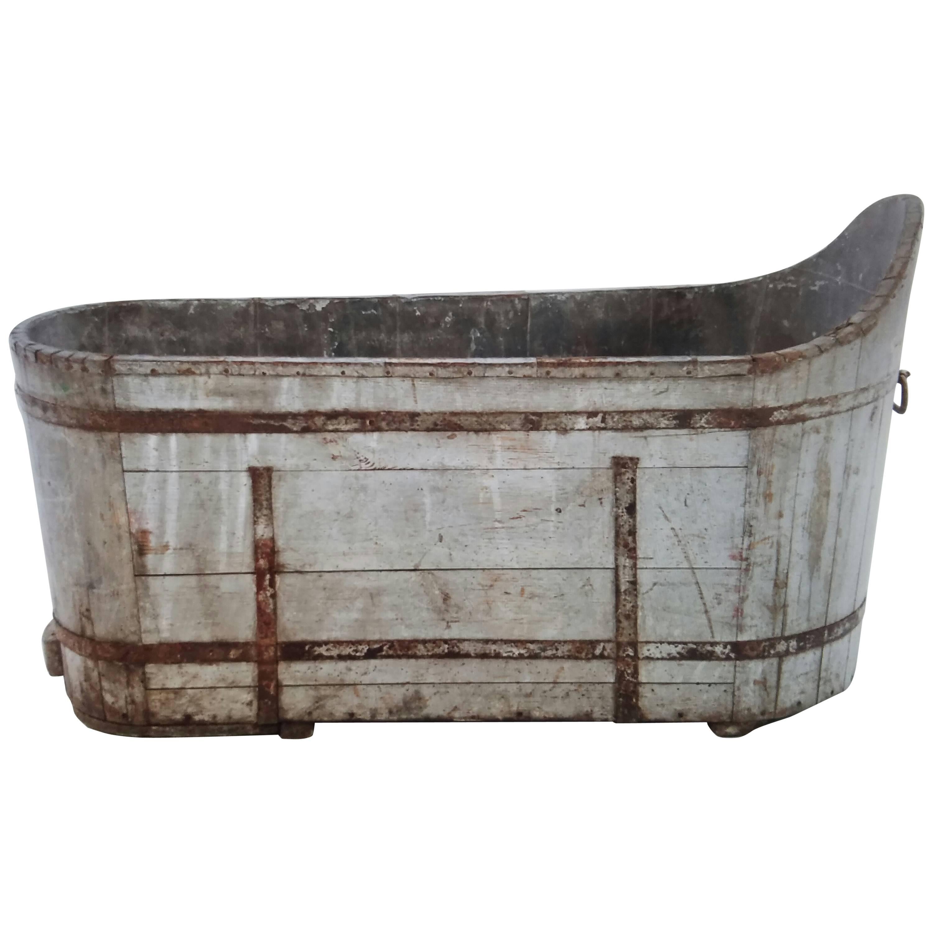 This 19th Century is the best garden planter ever! With its wonderful painted patina and original handle, the condition is very stable and intact. The handle is missing on one side but the interior is fully lined with sheet metal. Make a bench with