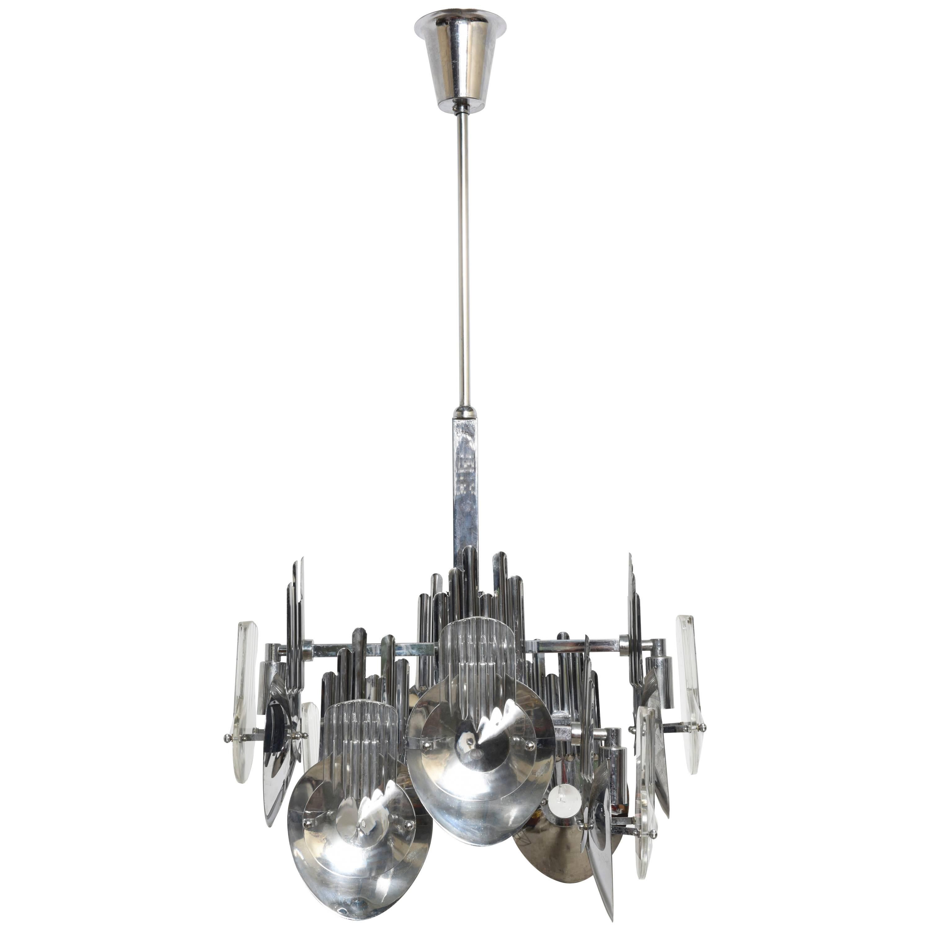 Twelve-light chandelier designed by Oscar Torlasco with optical Murano crystal glass reflectors attached to chrome screens mounted on center rod.