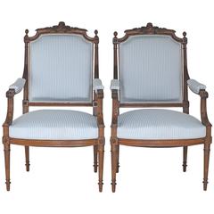 Pair of Antique French Upholstered Louis XVI Style Armchairs in Carved Walnut