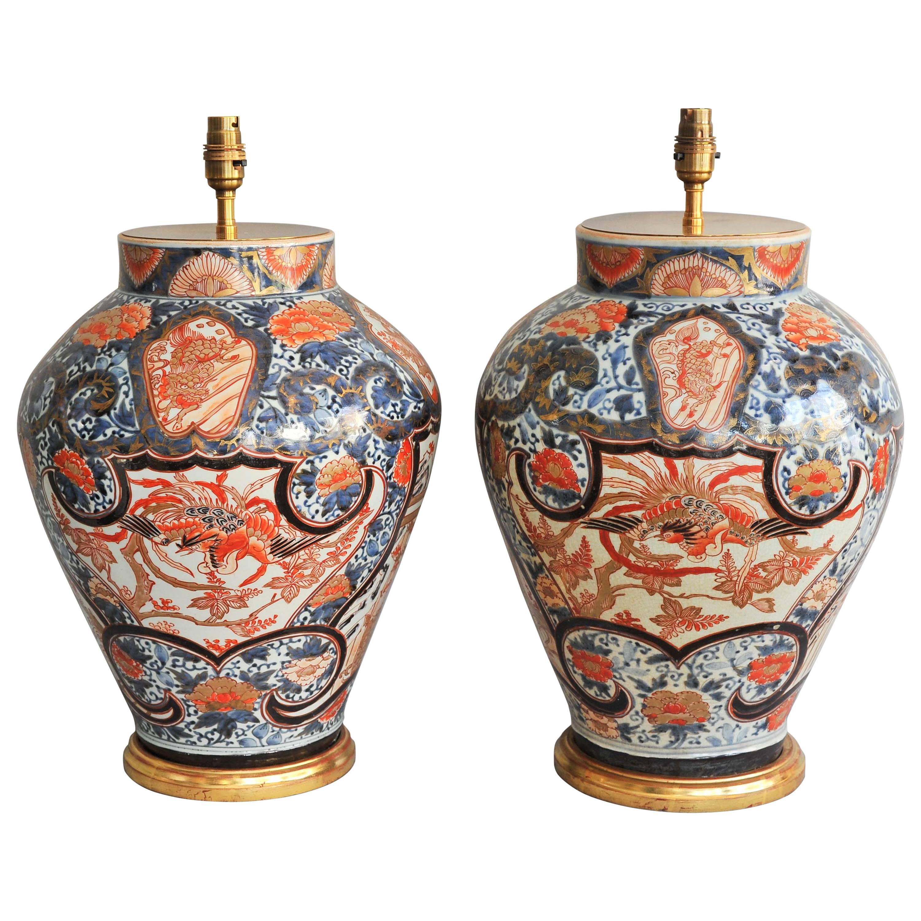 A Fine Pair of Early 18th Century Lamped Imari Vases on Gilt Bases