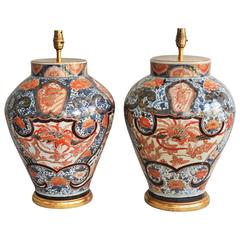 A Fine Pair of Early 18th Century Lamped Imari Vases on Gilt Bases