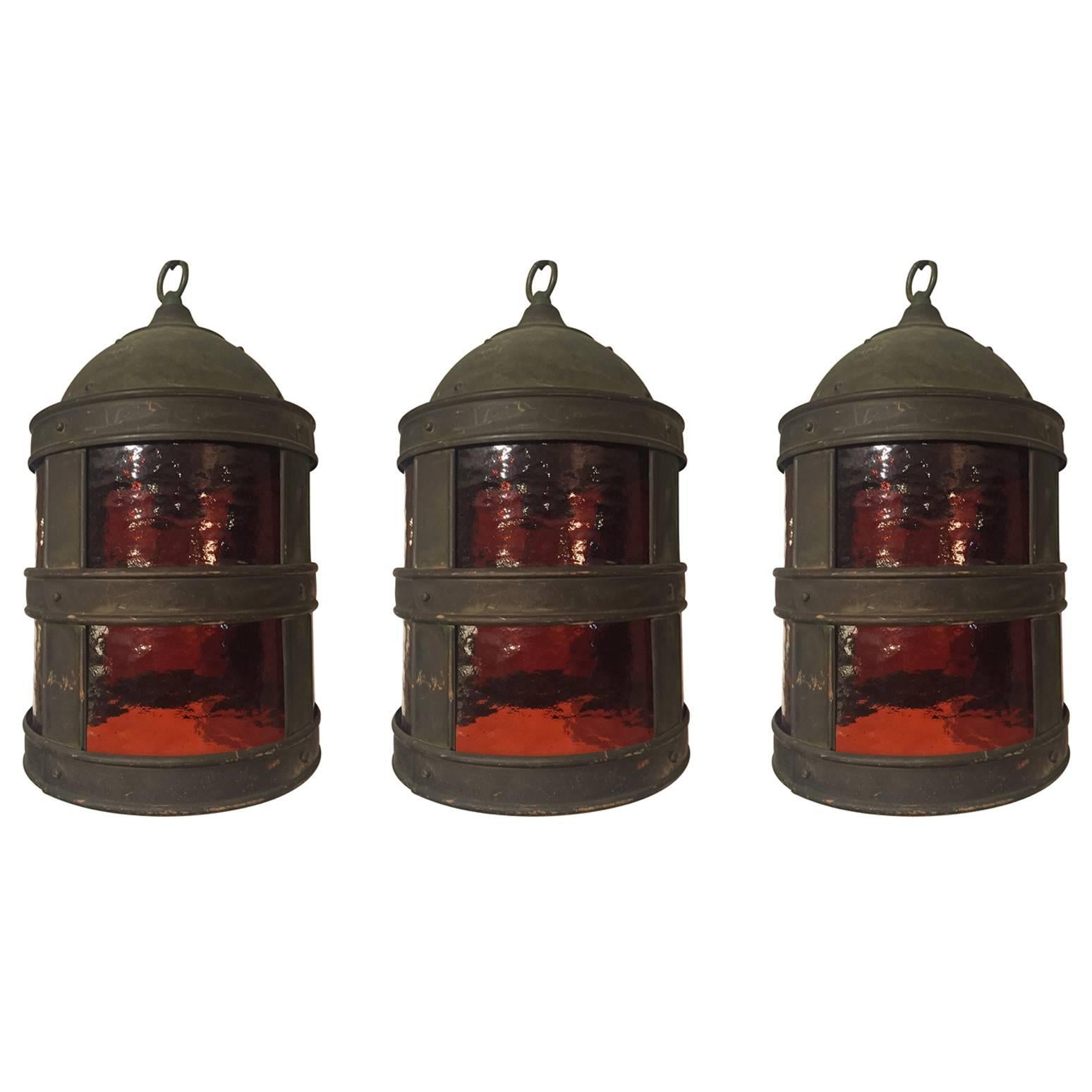 Set of Three Arts & Crafts Tole and Amber Glass Lanterns For Sale
