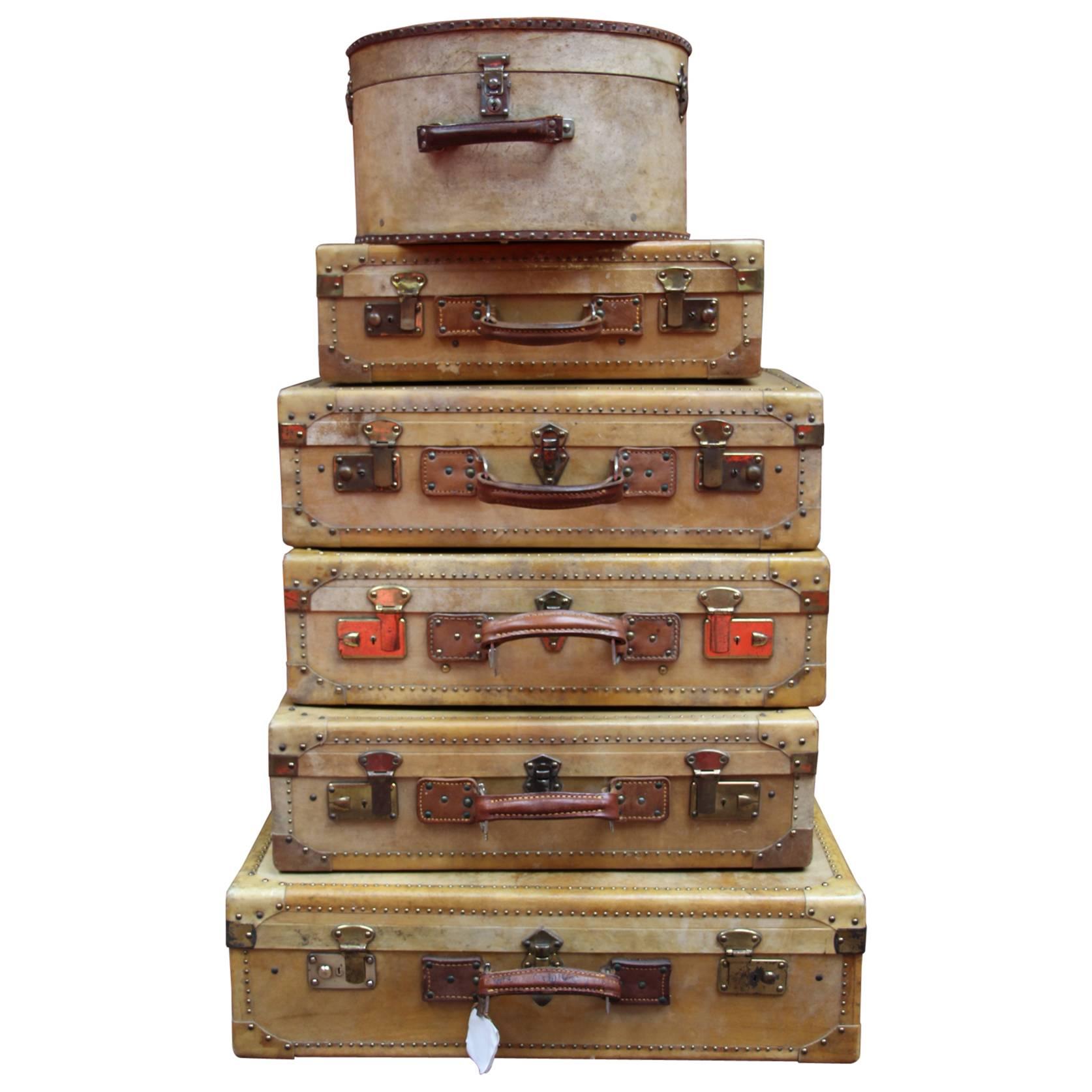 Set of Vellum Pieces of Luggage, Five Vellum Suitcases and One Round Hat Box