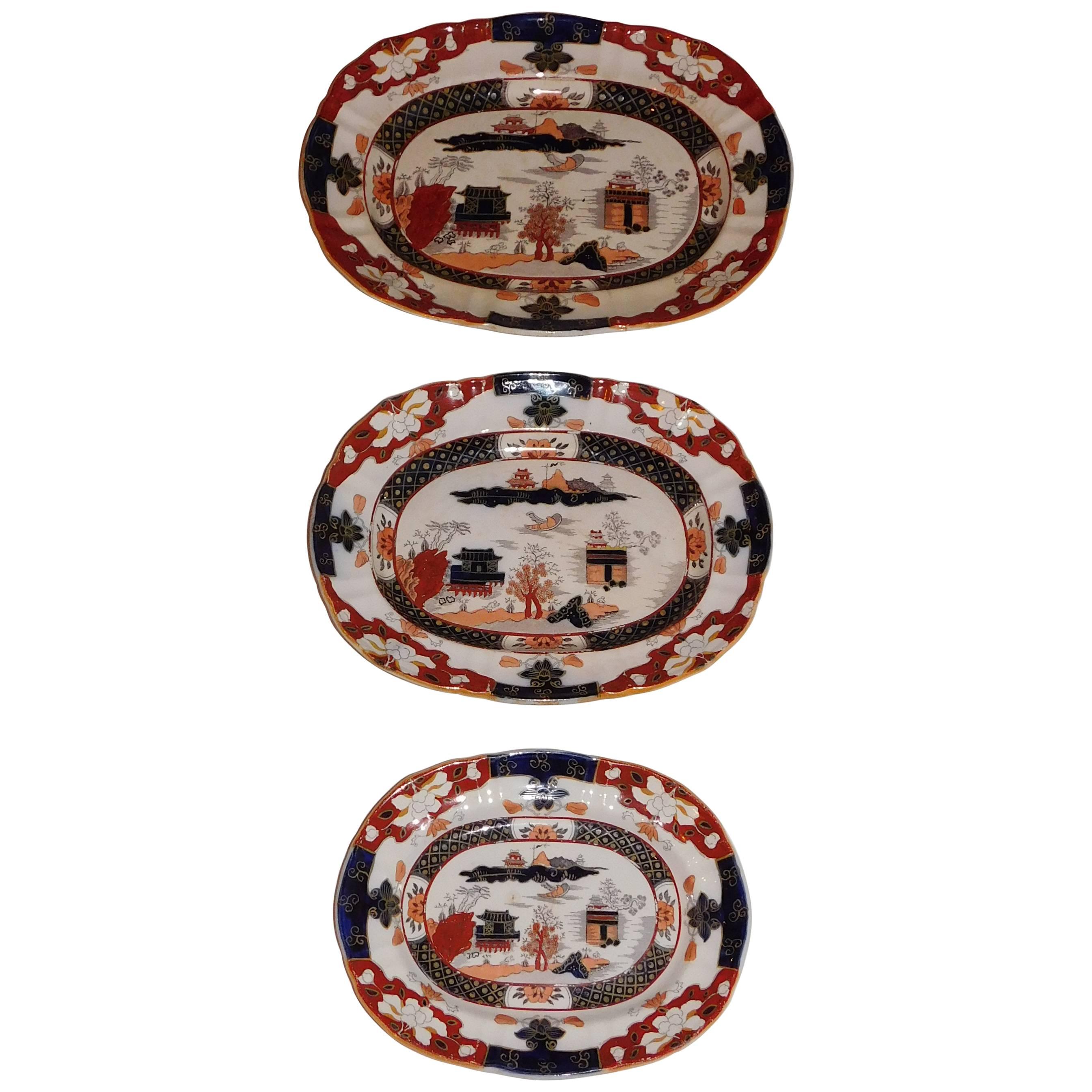 Design in the oriental taste, printed and impressed marks on back, polychrome decoration, ironstone. Measurements below are for the largest platter; others are 13.25" x 10.5" (middle) and 11" x 8.5" (smallest).
