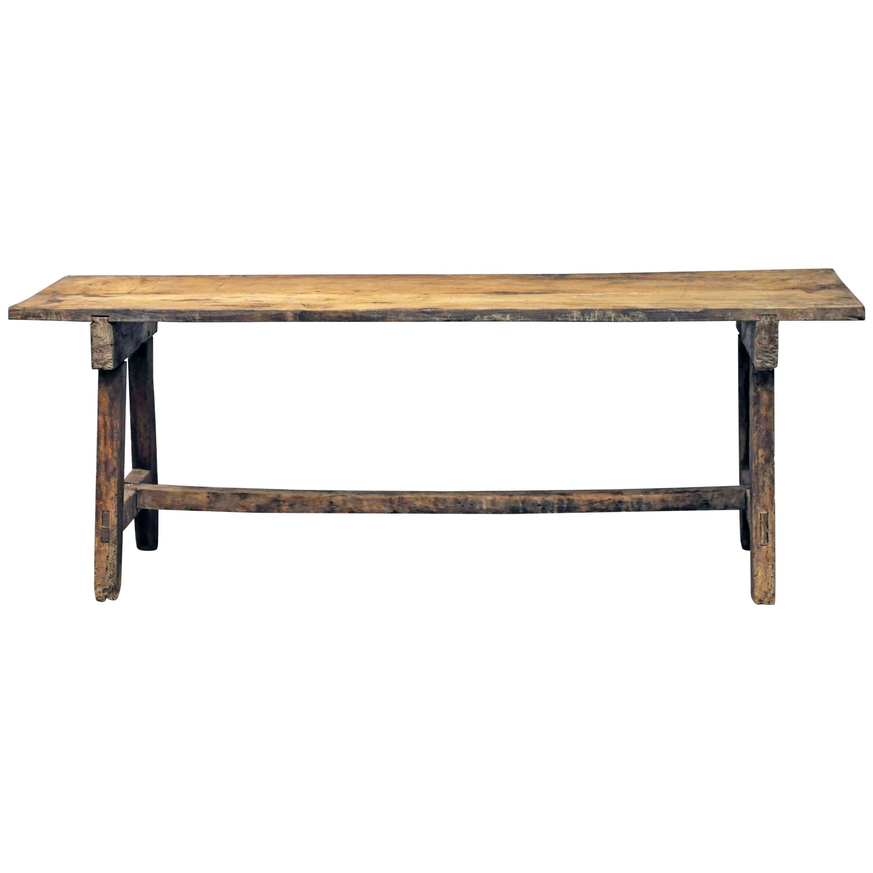 Early rustic Spanish style table, mortise construction and hard-wood; possibly chestnut or clear oak. 

Established in 1979, Joyce Horn Antiques, ltd. continues its 36 year tradition of being a family owned and operated business specializing in