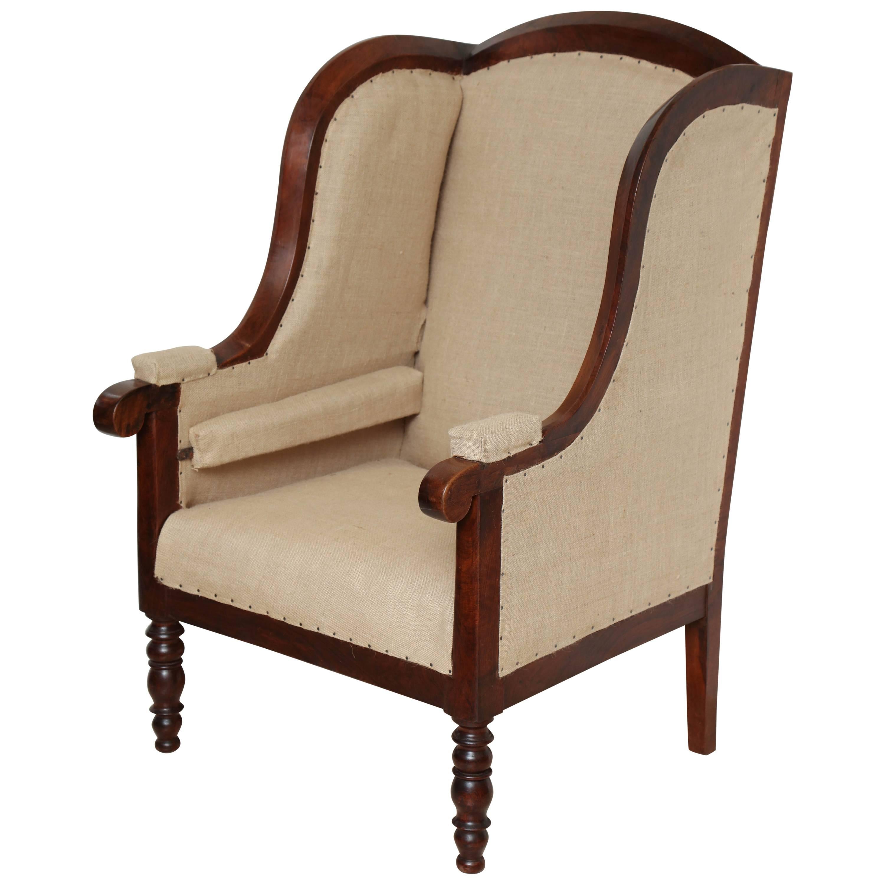 Early 19th Century French Walnut Upholstered Wing Chair For Sale