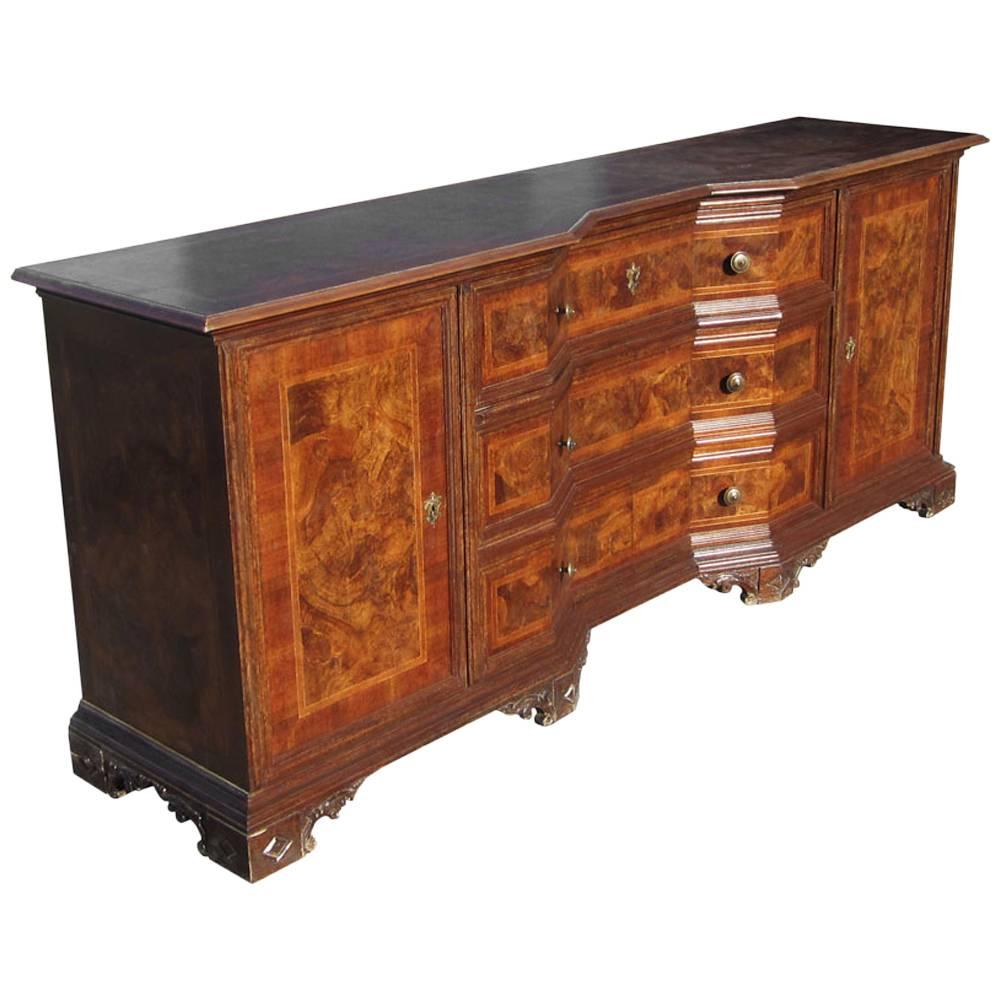 A vintage solid wood Italian credenza with linen lined drawers and cabinets. A stunning Italian design of solid wood makes this unique credenza a rare find. Cabinets open to expose pull out desk with ample storage. Made in Italy. Burled wood with