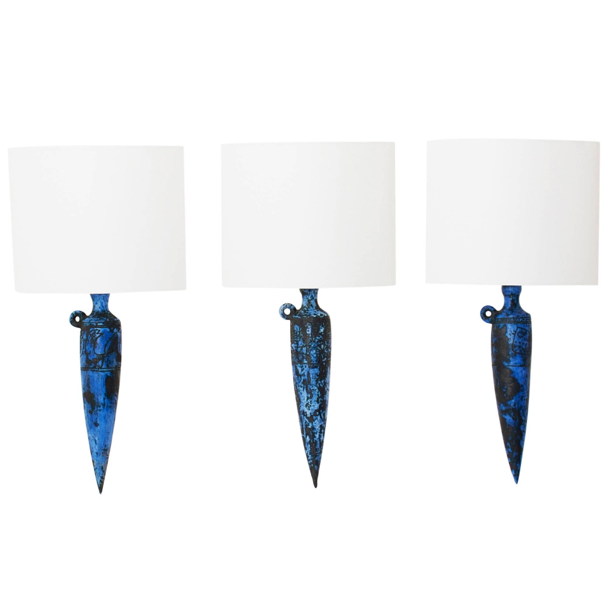 Rare set of three sconces by Jacques Blin. Each sconce has Primitive style Sgraffito decoration in blue glaze. Rewired and unoriginal shade.
