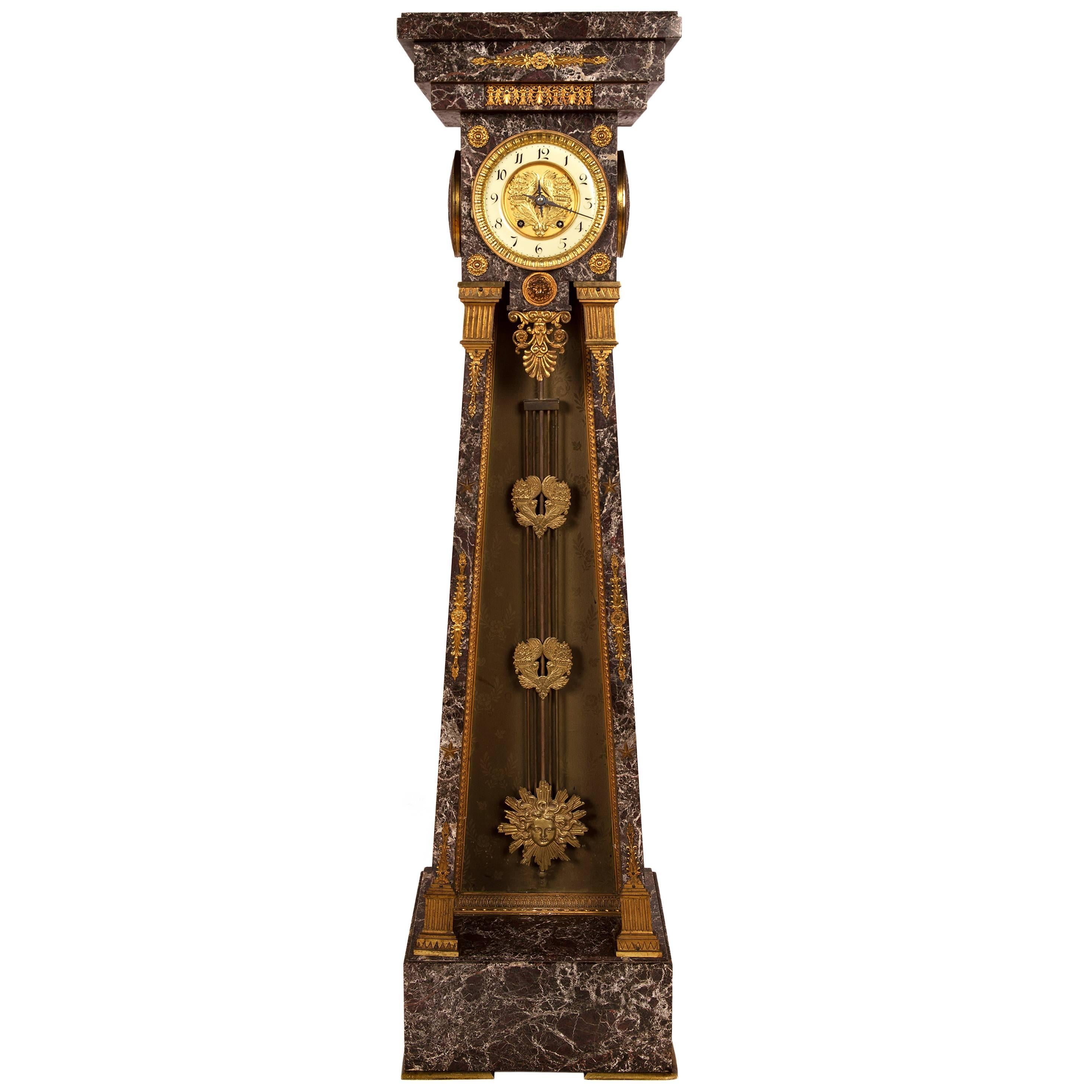 Empire Style Clock in a Marble Tapering Pedestal with a Sunburst Pendulum For Sale