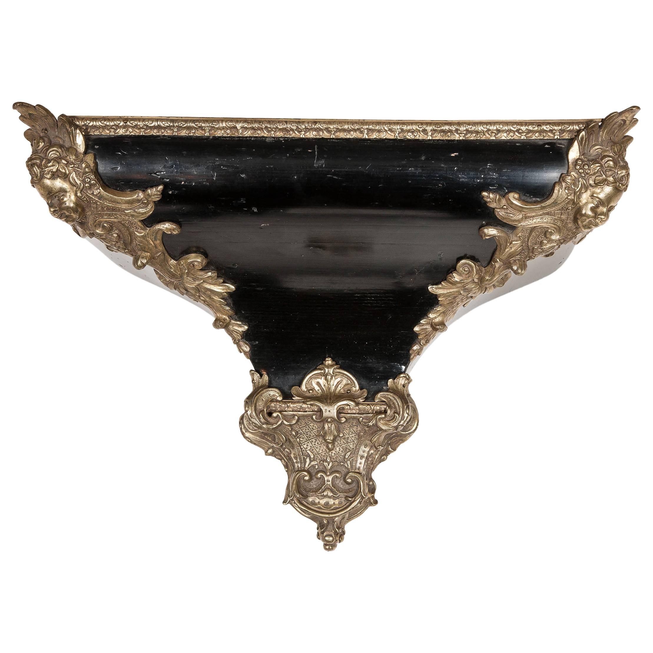 A Napoleon III ebonised French Louis XV style wall bracket with brass mounts