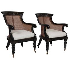 Pair of Late Regency Ebonized Caned Bergere Chairs