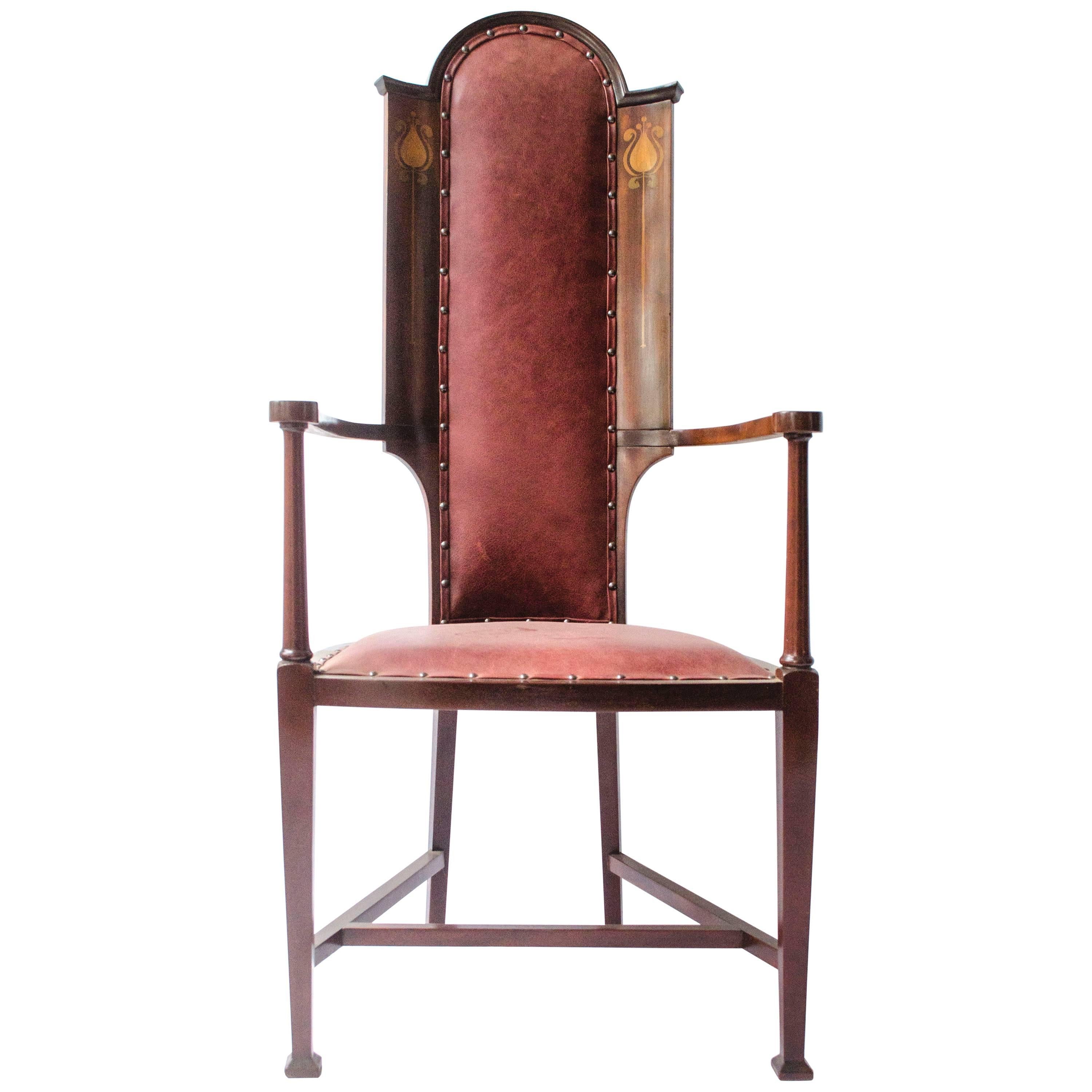J S Henry attr. An Arts & Crafts Mahogany Armchair With Stylised Floral Inlays
