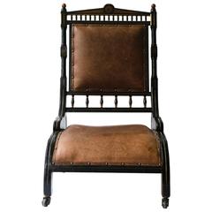 Richard Charles An Aesthetic Movement Ebonized and Parcel Gilt Lounge Chair.
