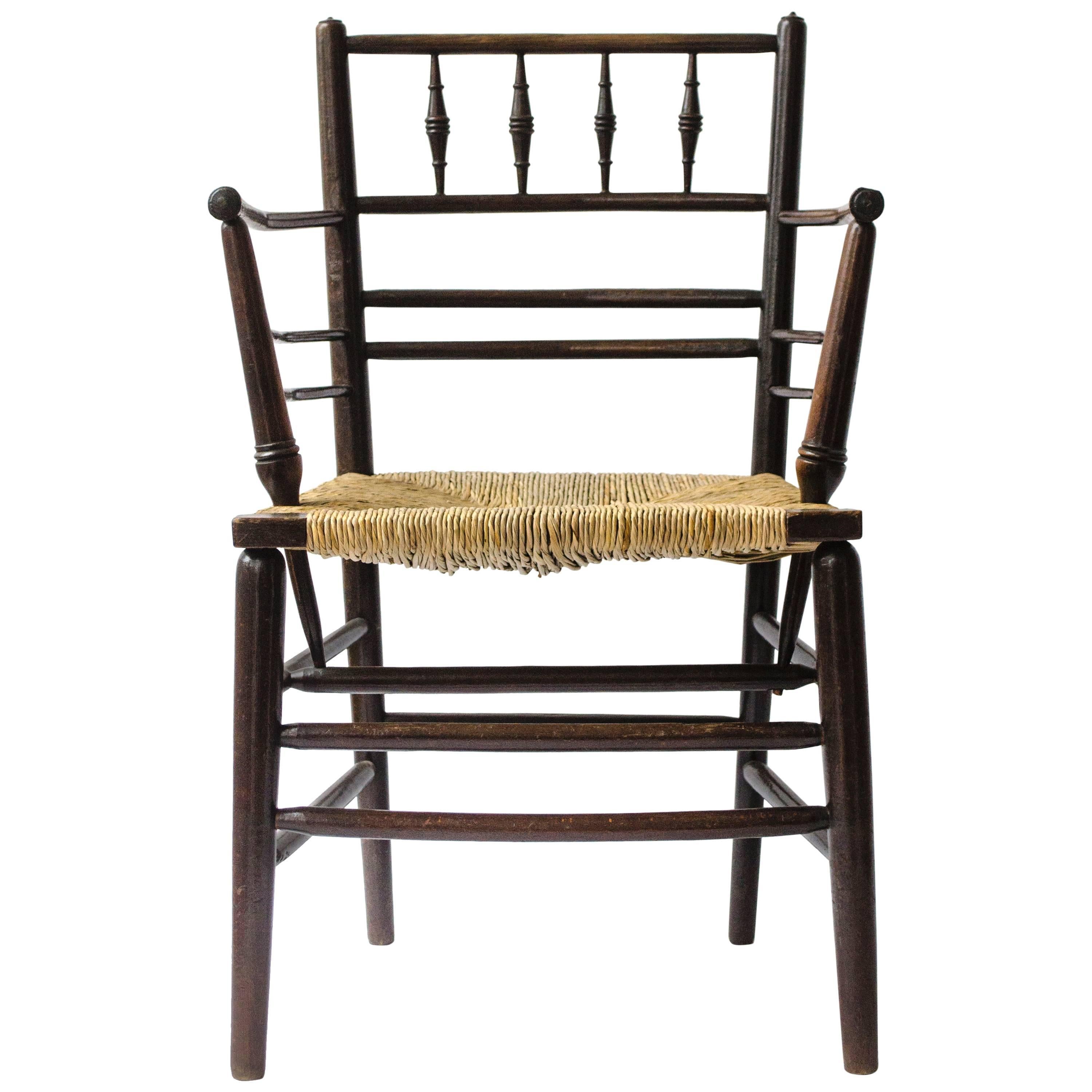 William Morris, An Arts and Crafts Ebonised Rush Seat Sussex Armchair