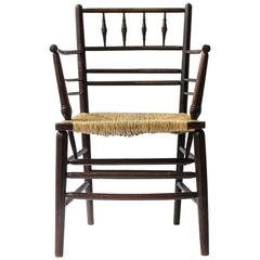 William Morris, An Arts and Crafts Ebonised Rush Seat Sussex Armchair
