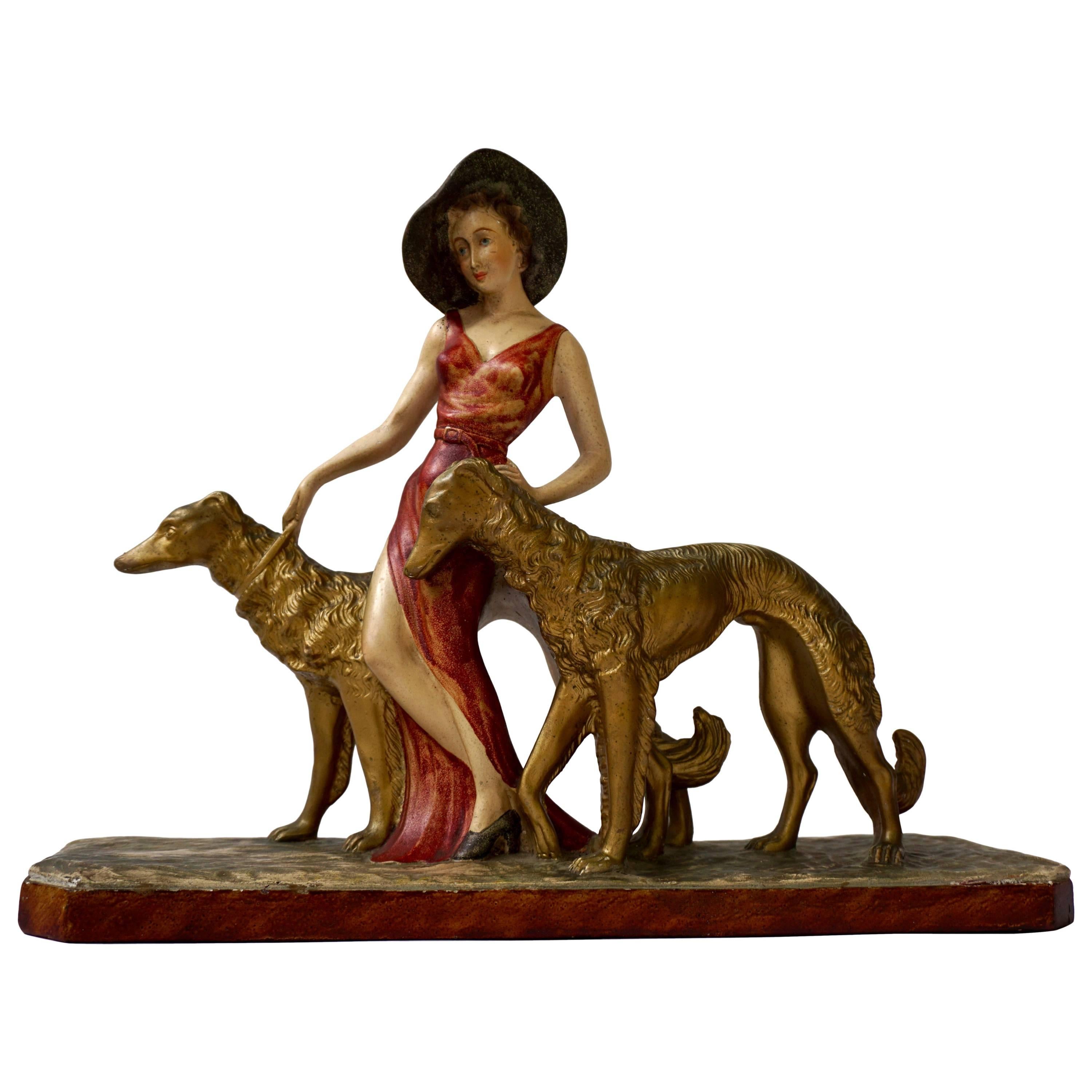 Painted Plaster Art Deco Figure of a Lady Walking Her Two Greyhounds, circa 1930
