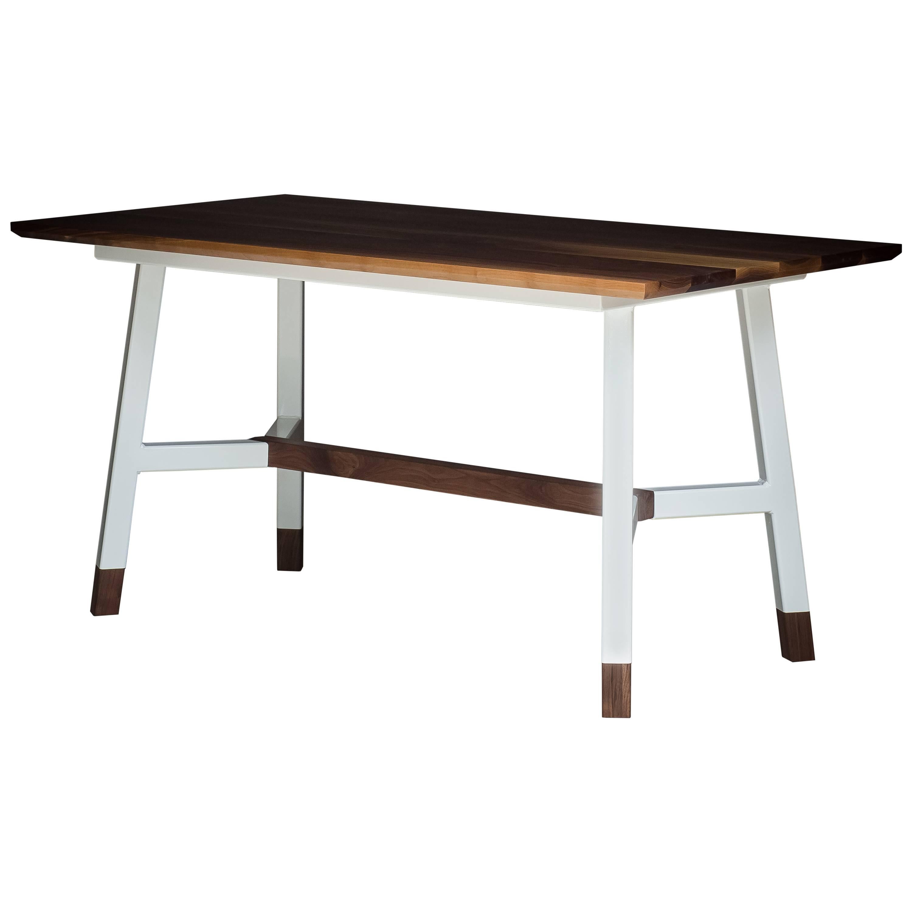 The A-Frame, Modern Walnut and Powder Coated Steel Dining Table.

Solid walnut table top with a chamfered edge. Powder coated welded steel base with solid hand-carved walnut feet and crossbar. The A-frame can be crafted from walnut or white oak and