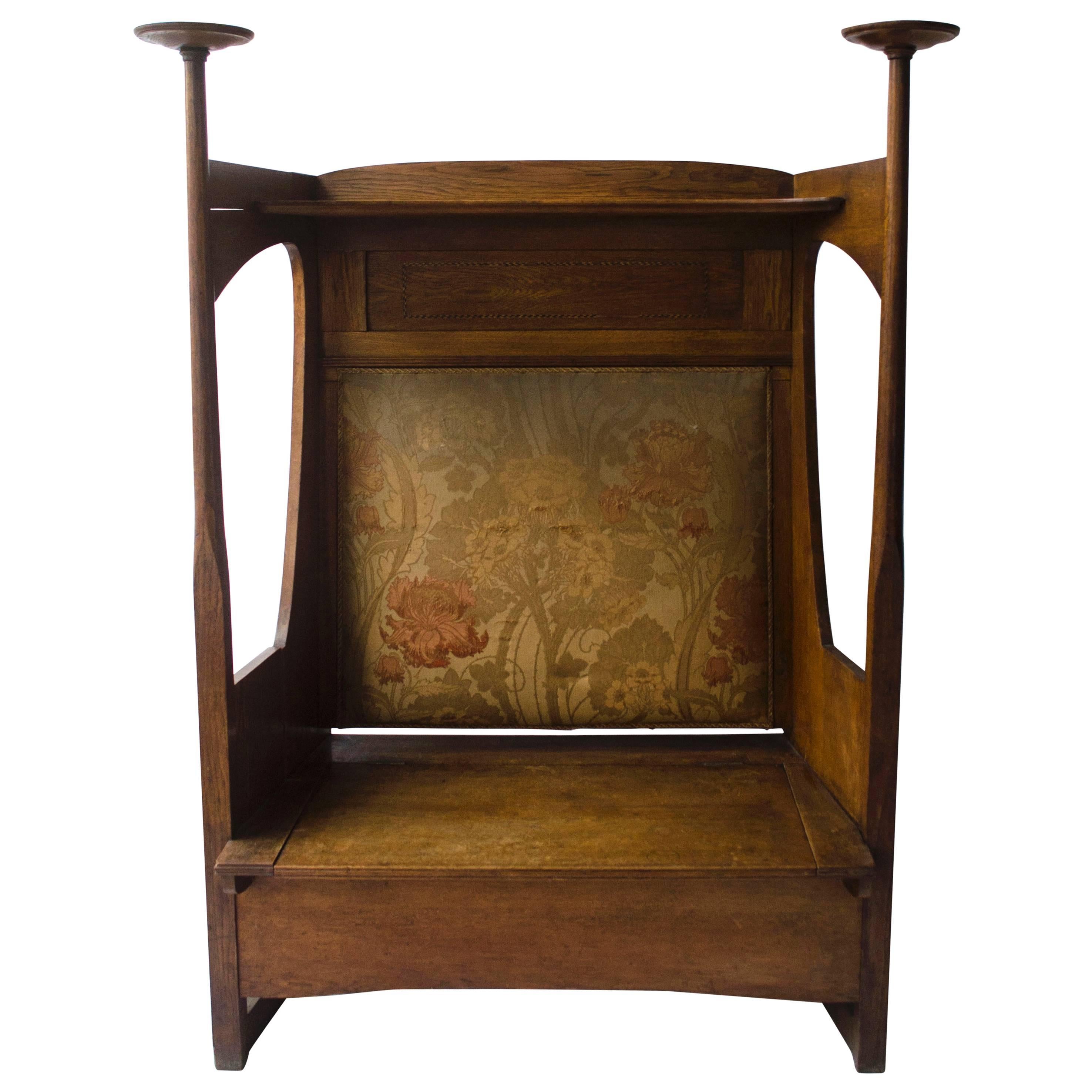 Liberty & Co. An Arts & Crafts Oak Settle in the Style of CFA Voysey