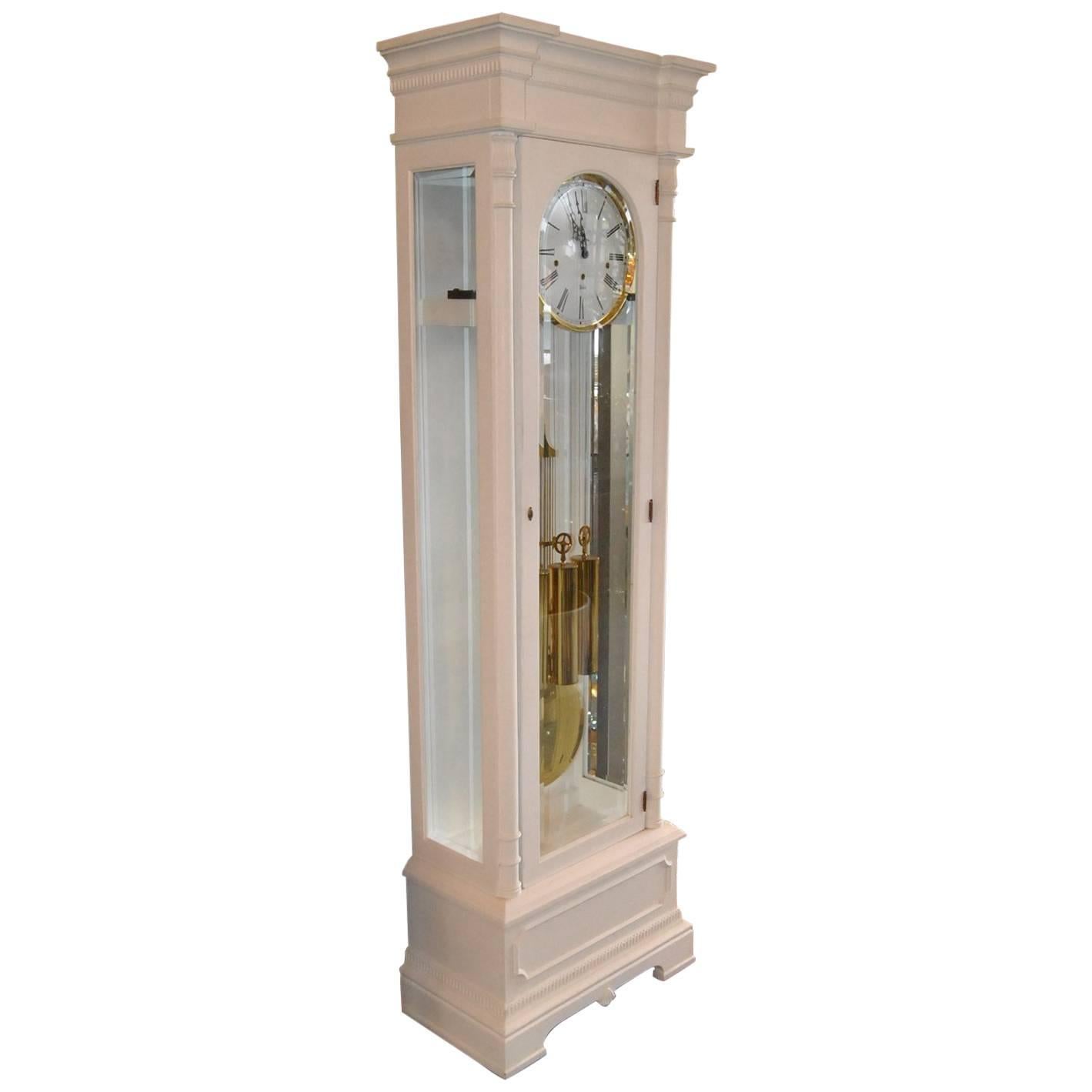 A beautiful Sligh Grandfather Clock in the sought out style, Classic Dorset. This clock has been professionally painted in white. The clock is an eight day key wound clock with triple chimes (Westminster, Whittington, St. Micheals). The round