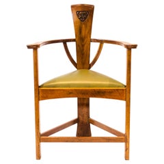 M H Baillie Scott. An Arts & Crafts Walnut Armchair with stylised floral carving