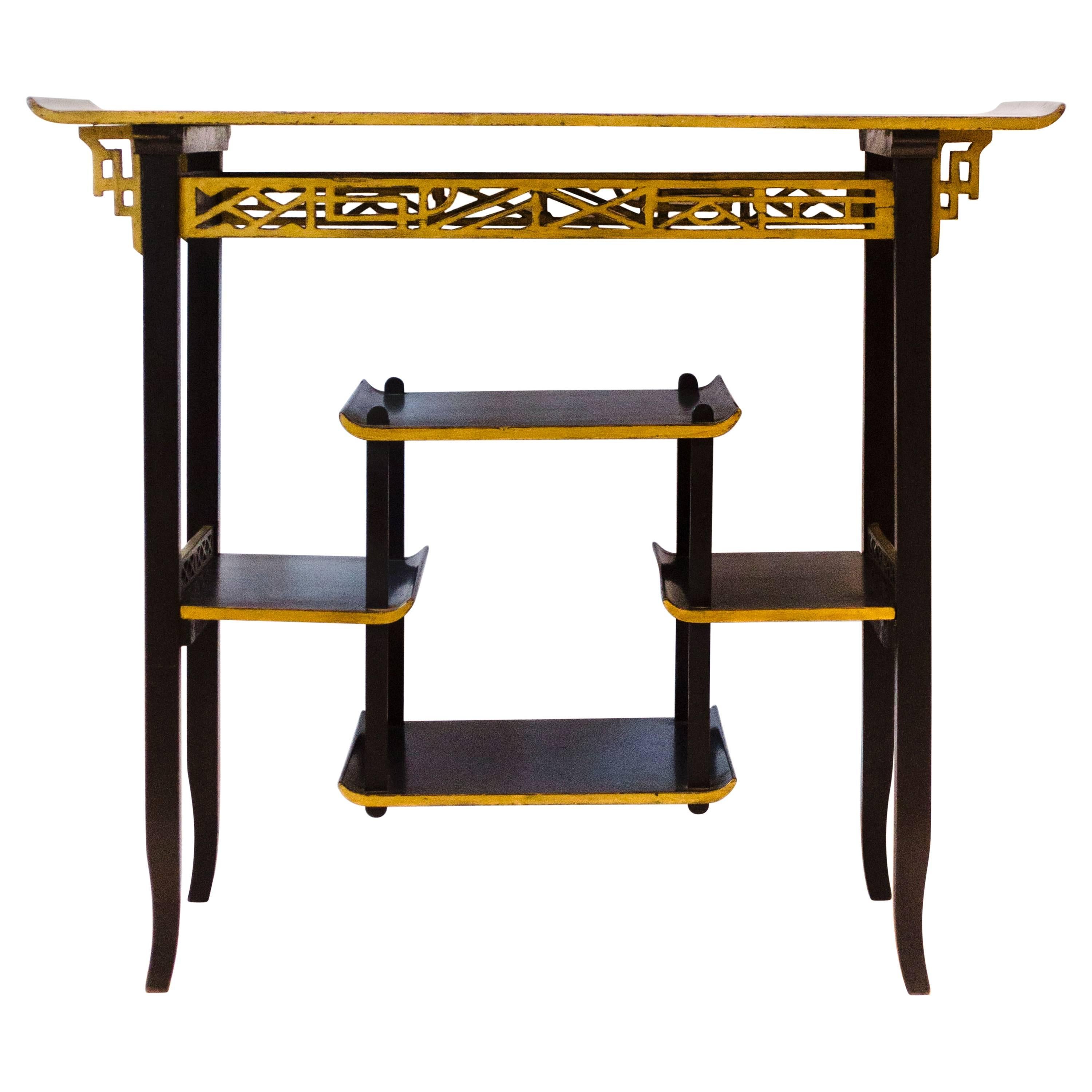 Heals. An Anglo-Japanese Ebonised Side Table with Gilt Fretwork and Flaring Ends For Sale