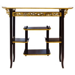 Heals. An Anglo-Japanese Ebonised Side Table with Gilt Fretwork and Flaring Ends