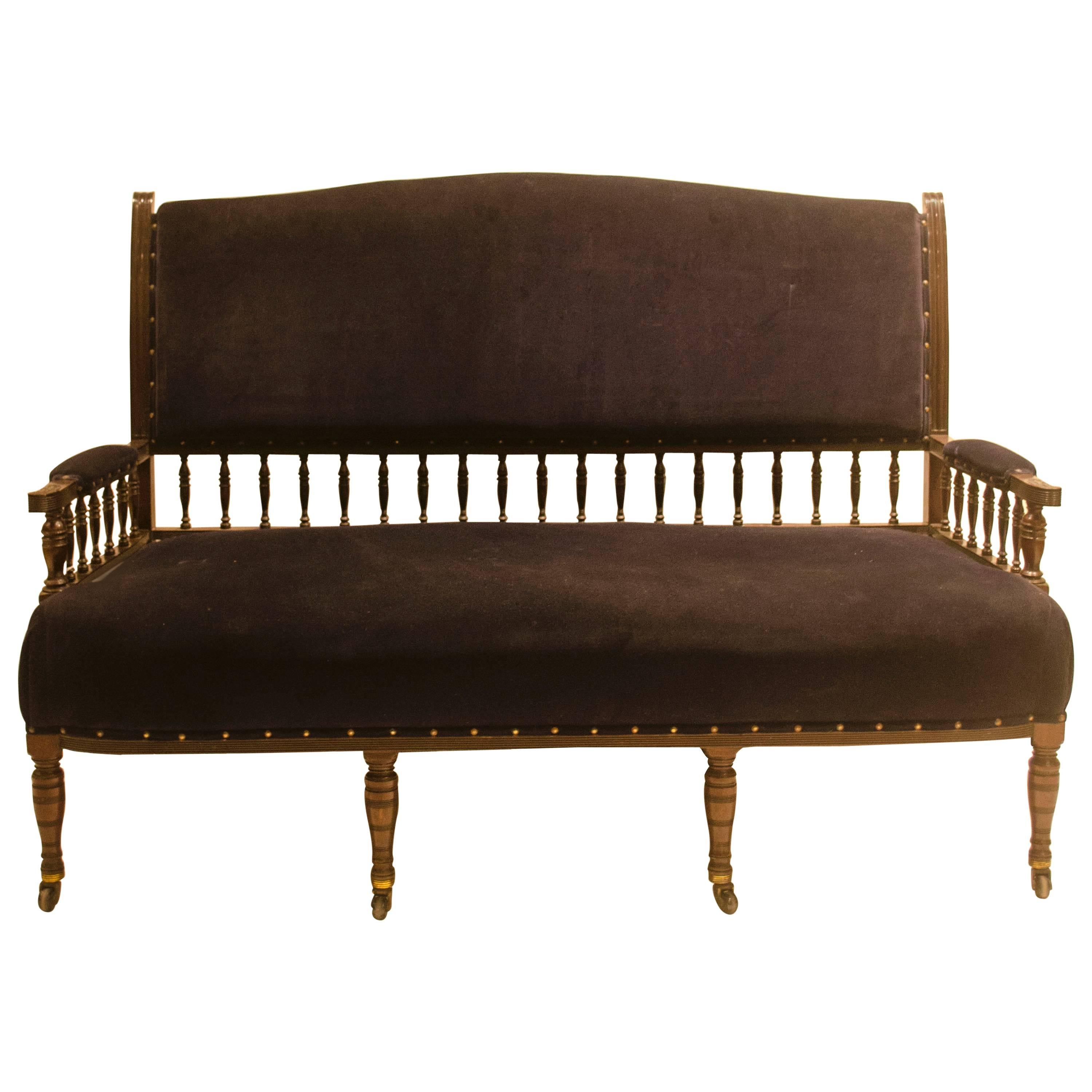 Collinson & Lock. An Anglo-Japanese Mahogany Settee with carved & scrolled arms For Sale