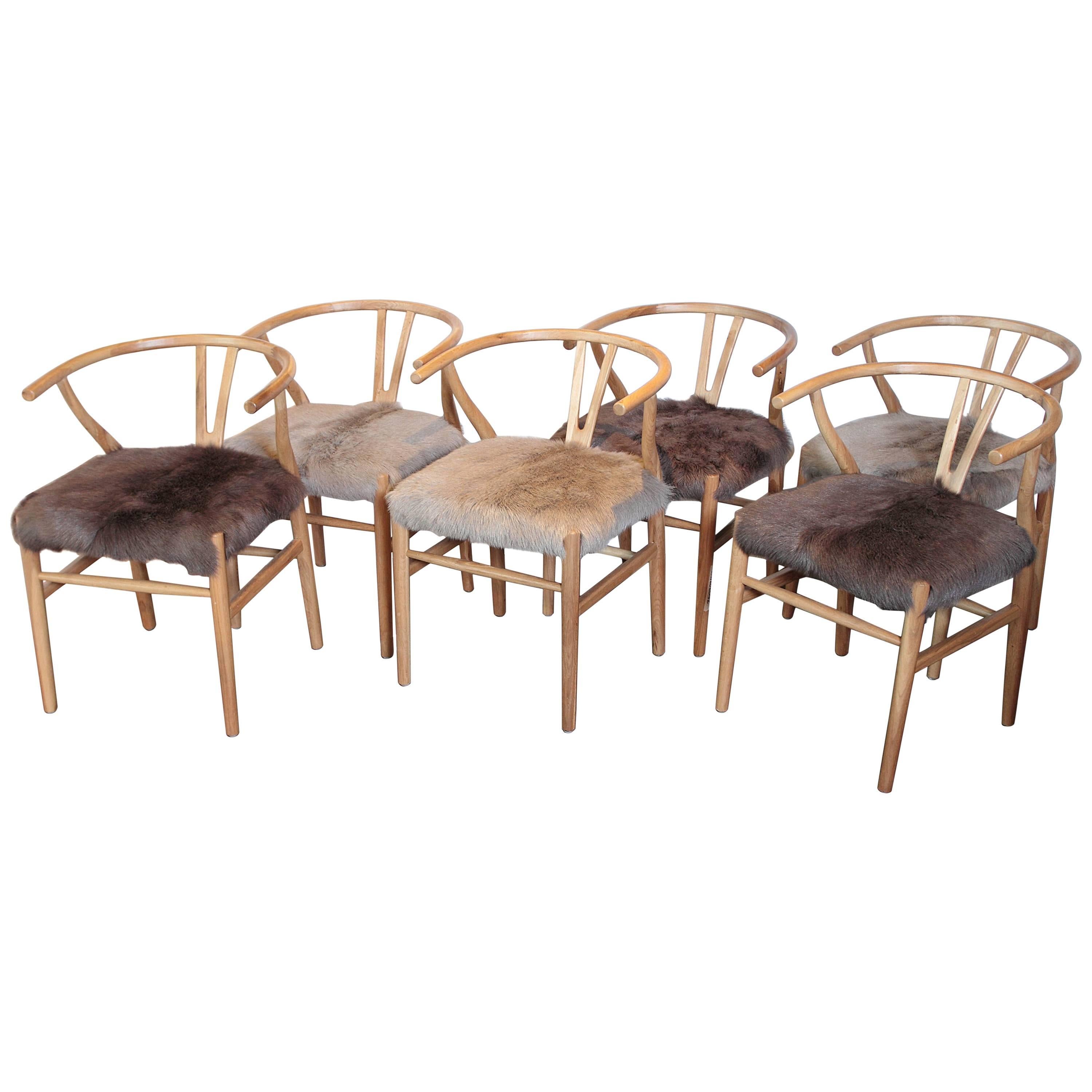 Scandinavian Modern fur dining chairs. 
Goat hide bentwood dining chairs. 

Available: Ten chairs in dark brown. 
Two chairs in light brown. 
(Each sold separately).