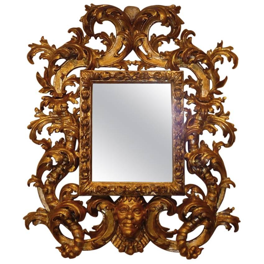 Rare Roman Baroque Carved and Giltwood Mirror, with a Grotesque Head, 1700 For Sale