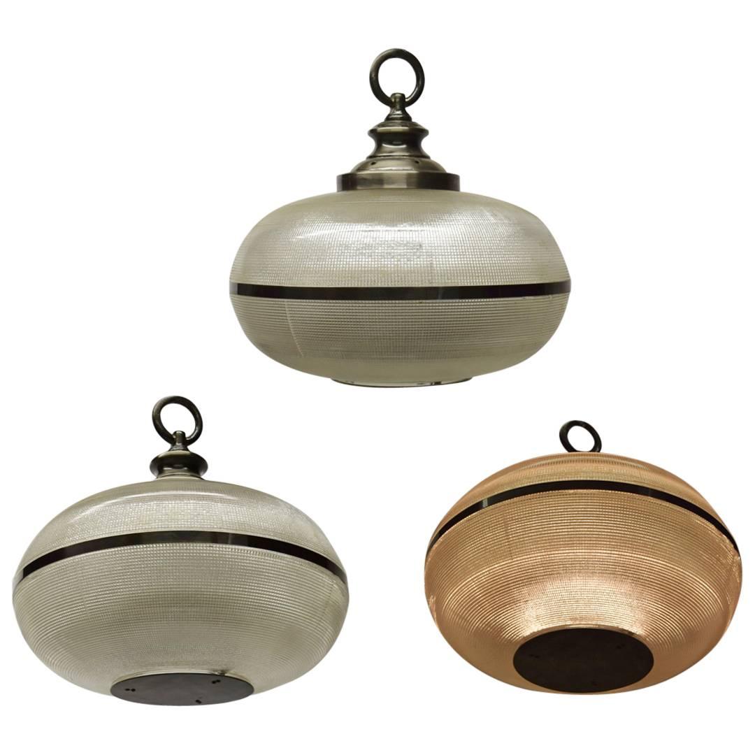 Saucer shaped ceiling fixture in holophane glass with custom patinated bronze fittings and a single socket that can handle 200 watts if needed.
 