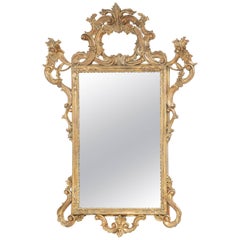 Miroir rococo italien en bois doré sculpté